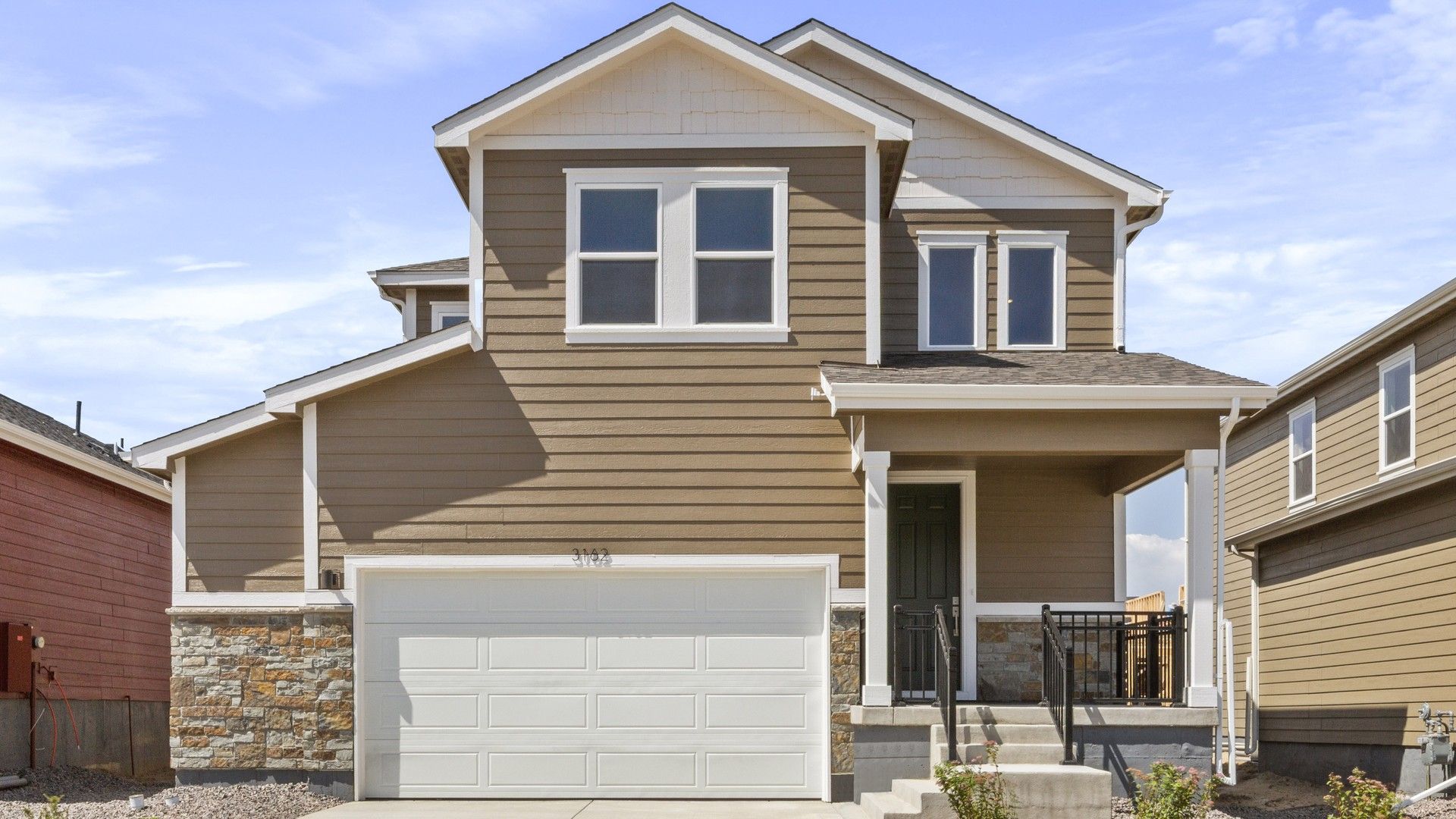 Modern Two-Story Home with Stone Accents in Suburban Area:Elegant two-story architecture with stone accents and spacious garage exuding suburban luxury.