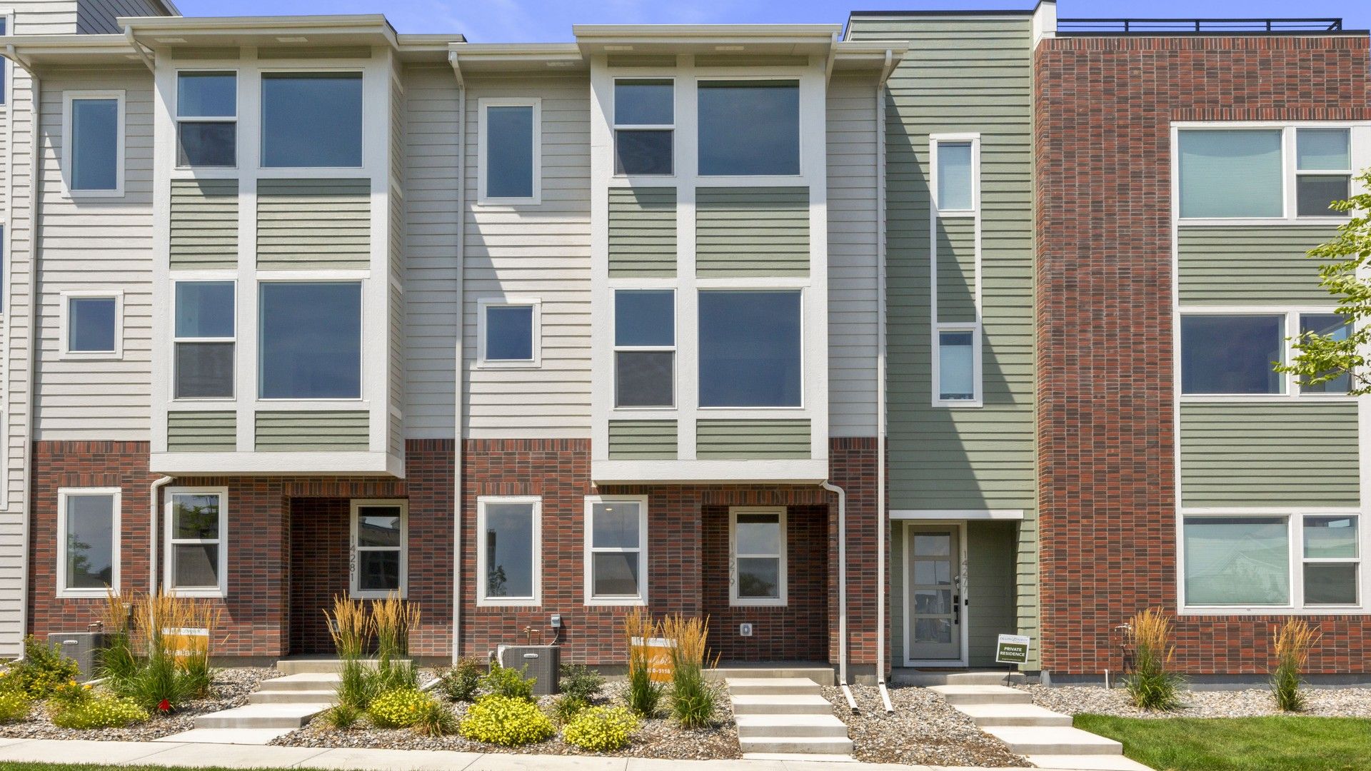 Contemporary Townhouses in Dillon Pointe with Brick and Siding:Sleek townhomes feature expansive windows and modern brickwork in the esteemed Dillon Pointe community.