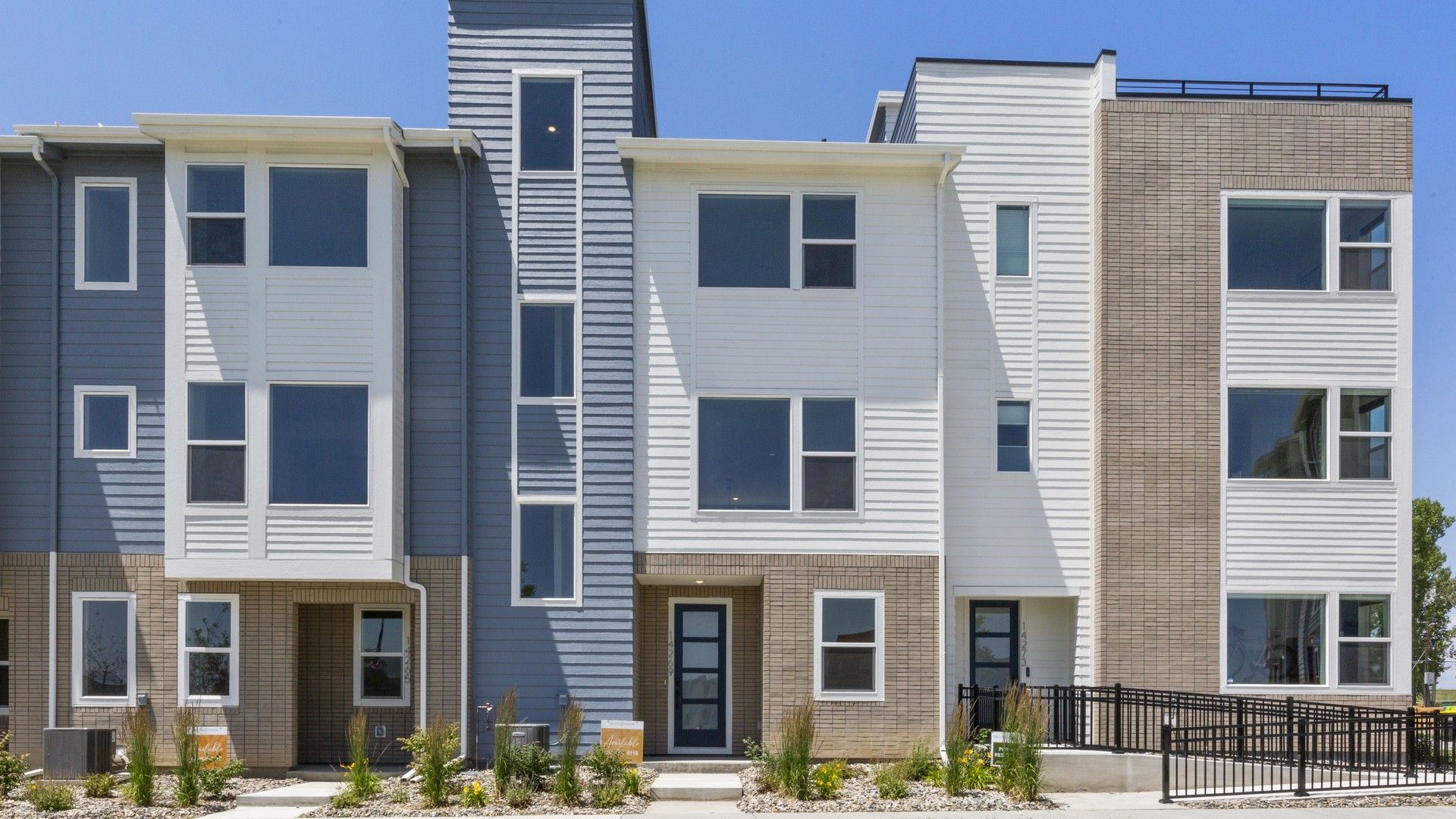 Columbia at Dillon Pointe Modern Townhomes:Sleek design with contrasting siding and expansive windows at Columbia at Dillon Pointe.