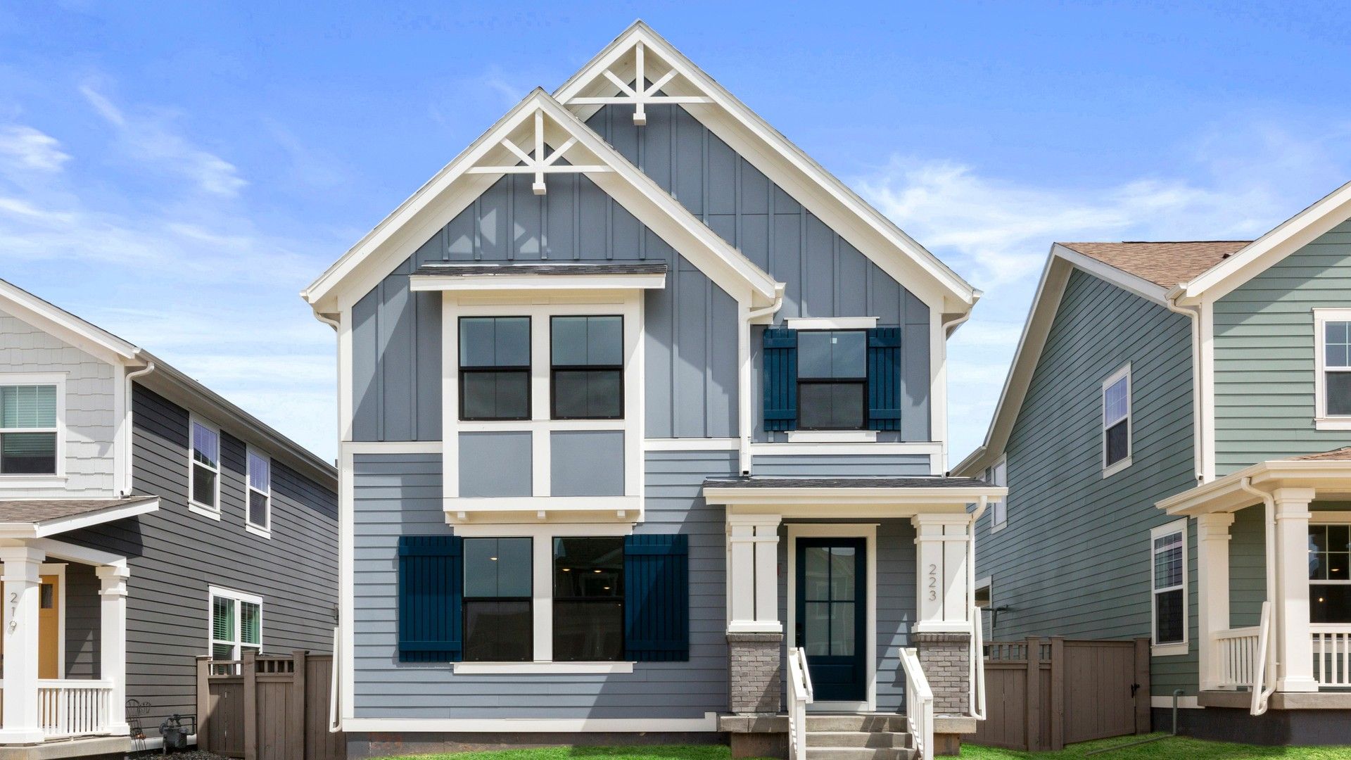 Contemporary Home with Gabled Roof in Westerly Neighborhood:Elegant gabled roof and sophisticated blue-gray facade define this Westerly gem.