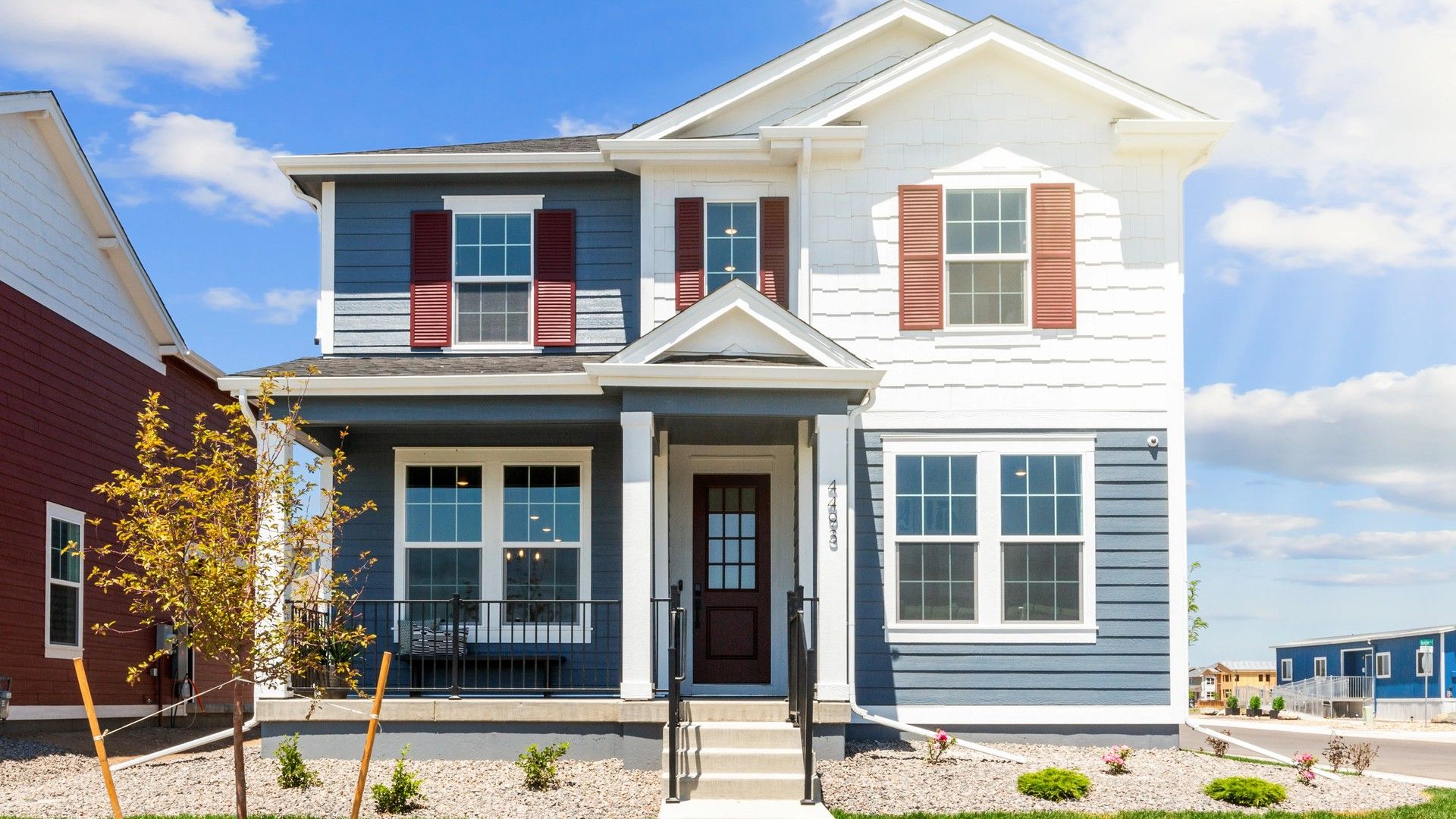 Two-Story House with Blue Siding in Timnath Lakes:Stunning blue and white exterior with classic pergola entry. Located in the sought-after Timnath Lakes.