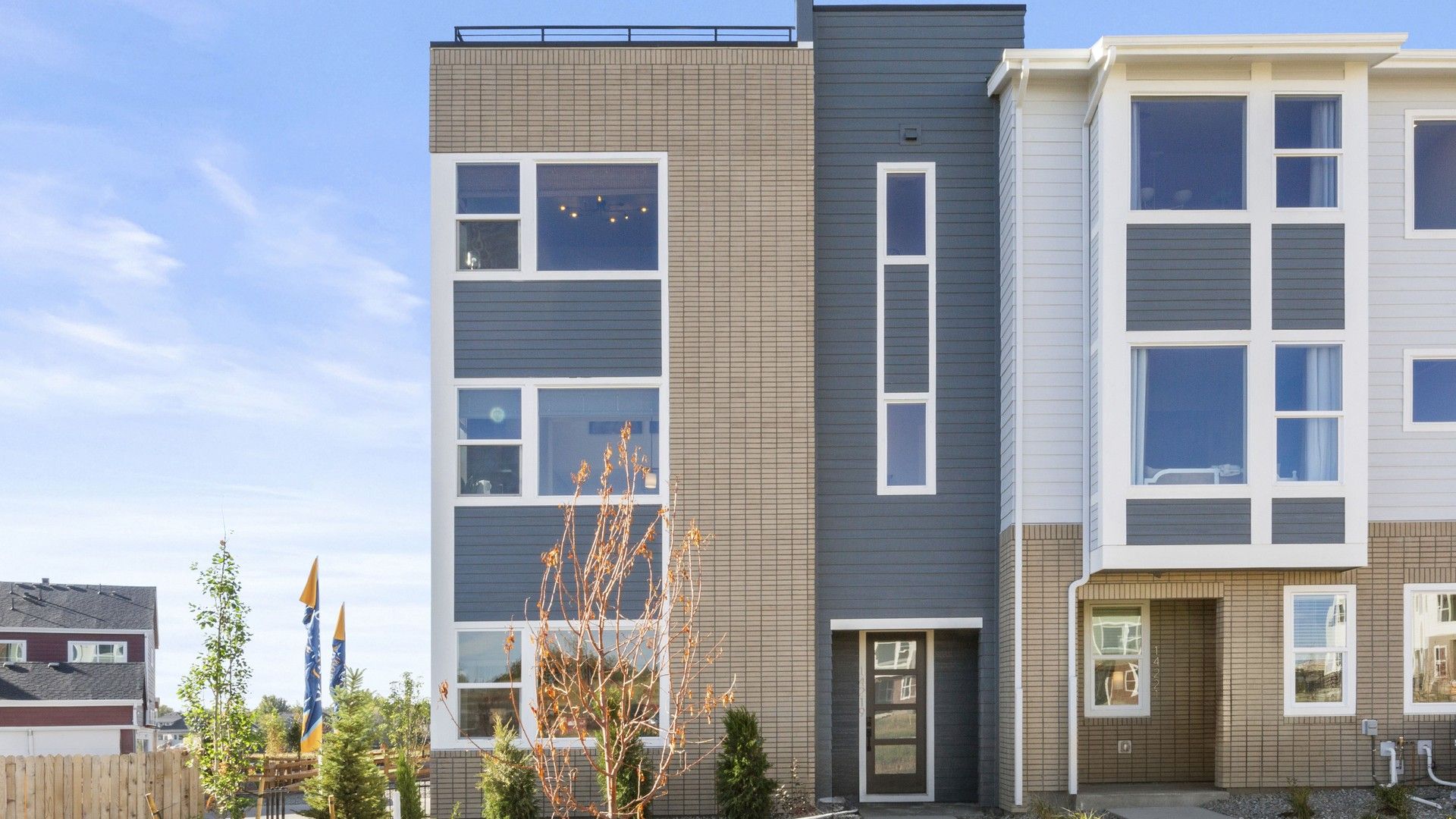 Contemporary Townhouse with Brick Facade in Dillon Pointe:Elegant brick facade and expansive windows define this Dillon Pointe townhouse's modern luxury.