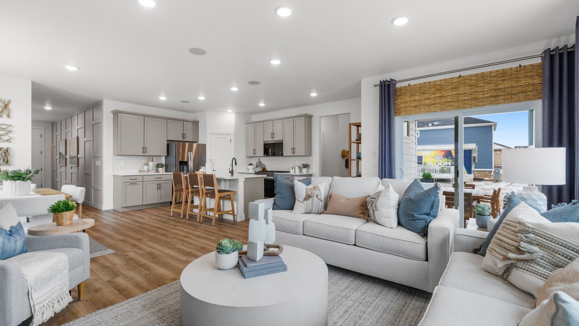 Open-Concept Living Room with Modern Kitchen in Bloom, Colorado:Elegant kitchen island, plush seating, and wood finishes enhance luxury in this Bloom, Colorado home.