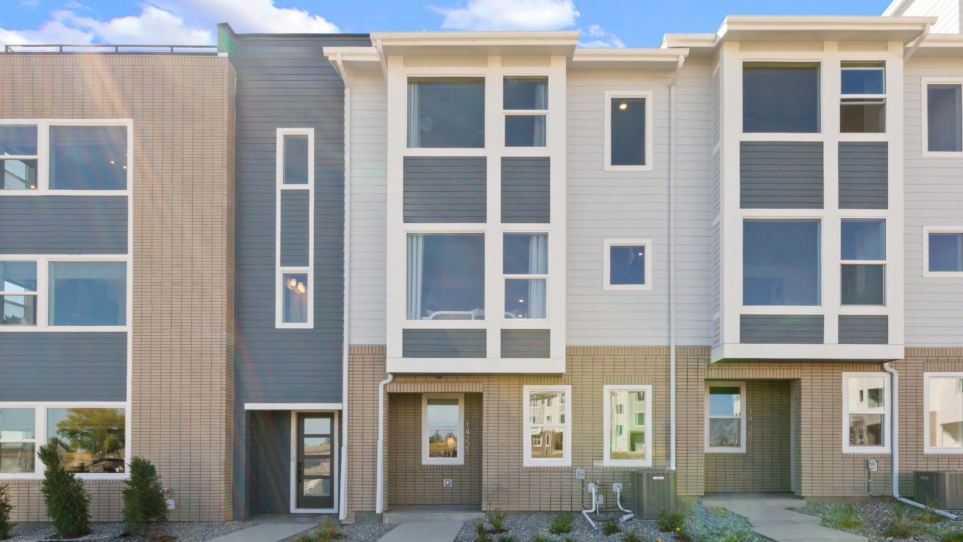 Modern Townhouse Exterior in Dillon Pointe Community:Elegant modern design with expansive windows and refined brickwork in Dillon Pointe, offering sophisticated luxury.