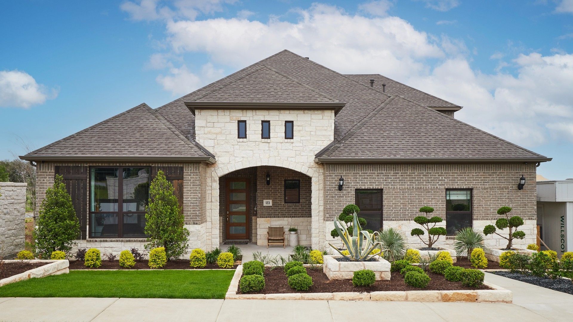 Luxury Stone and Brick Home in Anthem Community:Elegant blend of stone and brick facade with lush landscaping, Anthem community.