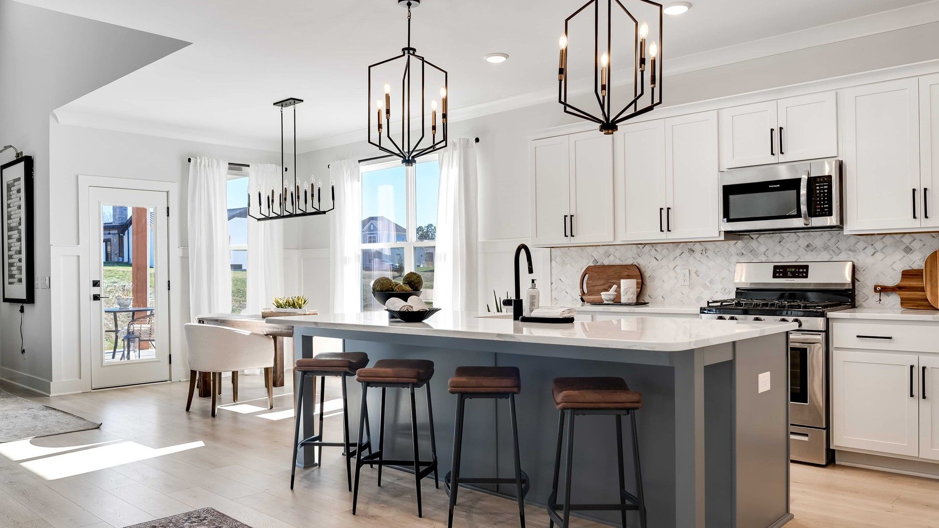 Modern Kitchen Island in Brush Creek:Exquisite kitchen in Brush Creek features quartz countertops, chic pendant lighting, and sleek cabinetry.