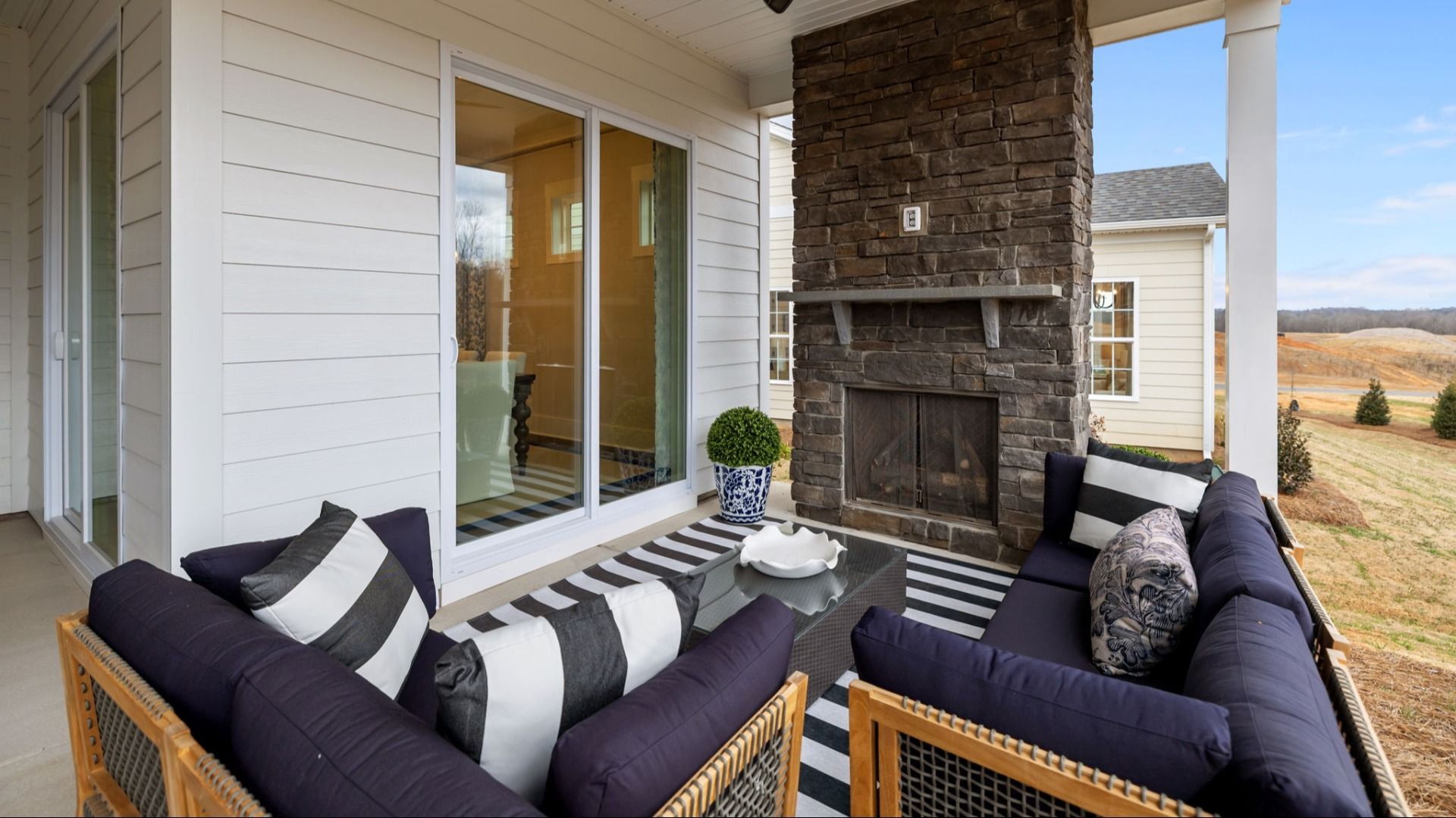 The Adventurer Plan by DBR Homes with a spacious rear porch in Fort Mill, SC:The Adventurer Plan by DBR Homes with a spacious rear porch and stone fireplace in Fort Mill, SC