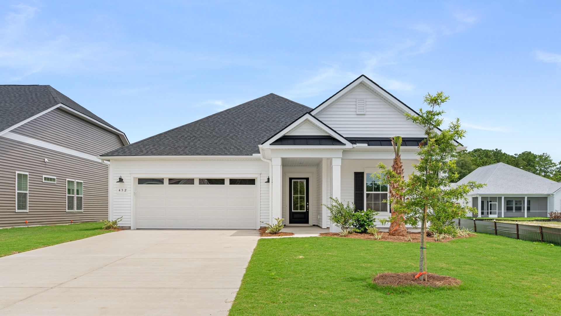 Exterior- Front:Charming front exterior with covered entry and two-car garage at 432 Summerwind Drive in Summerwind Crossing, Summerville