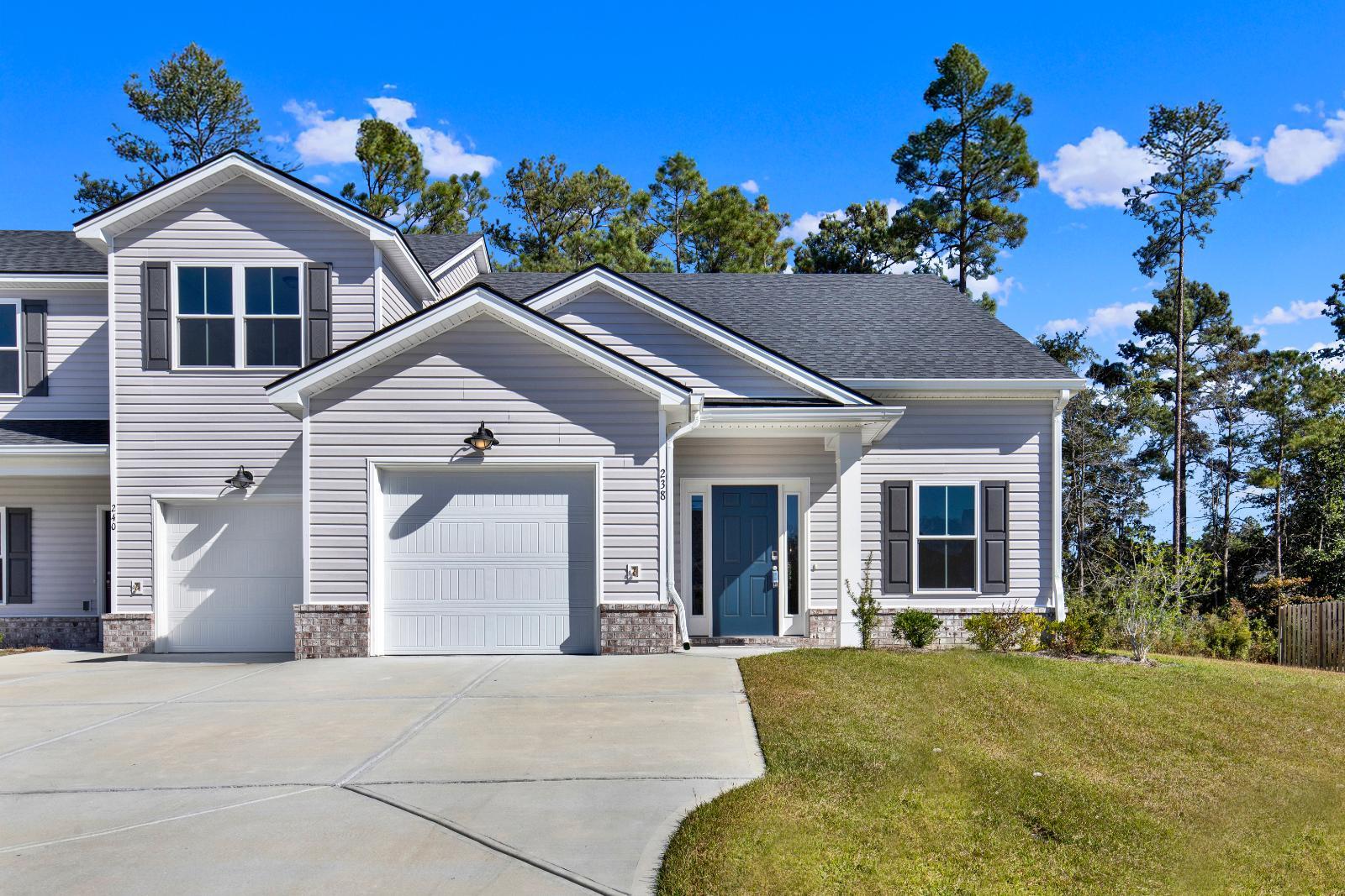 New Haven Townhome A plan exterior front view in 238 Haisley Run Guyton, GA community:New Haven Townhome A - Front Elevation 238 Haisley Run | Ernest Homes