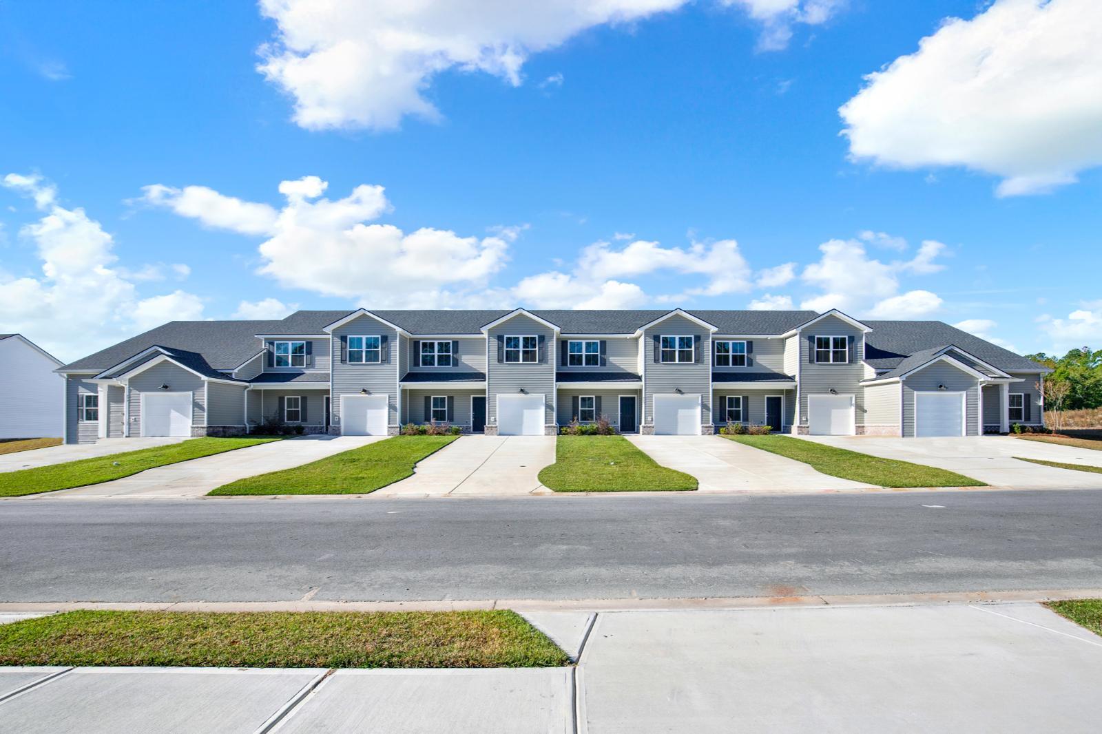 Exterior view of New Haven townhomes including 241 Haisley Run in Guyton, GA:241 Haisley Run New Haven Townhome B Exterior Streetscape – Guyton GA