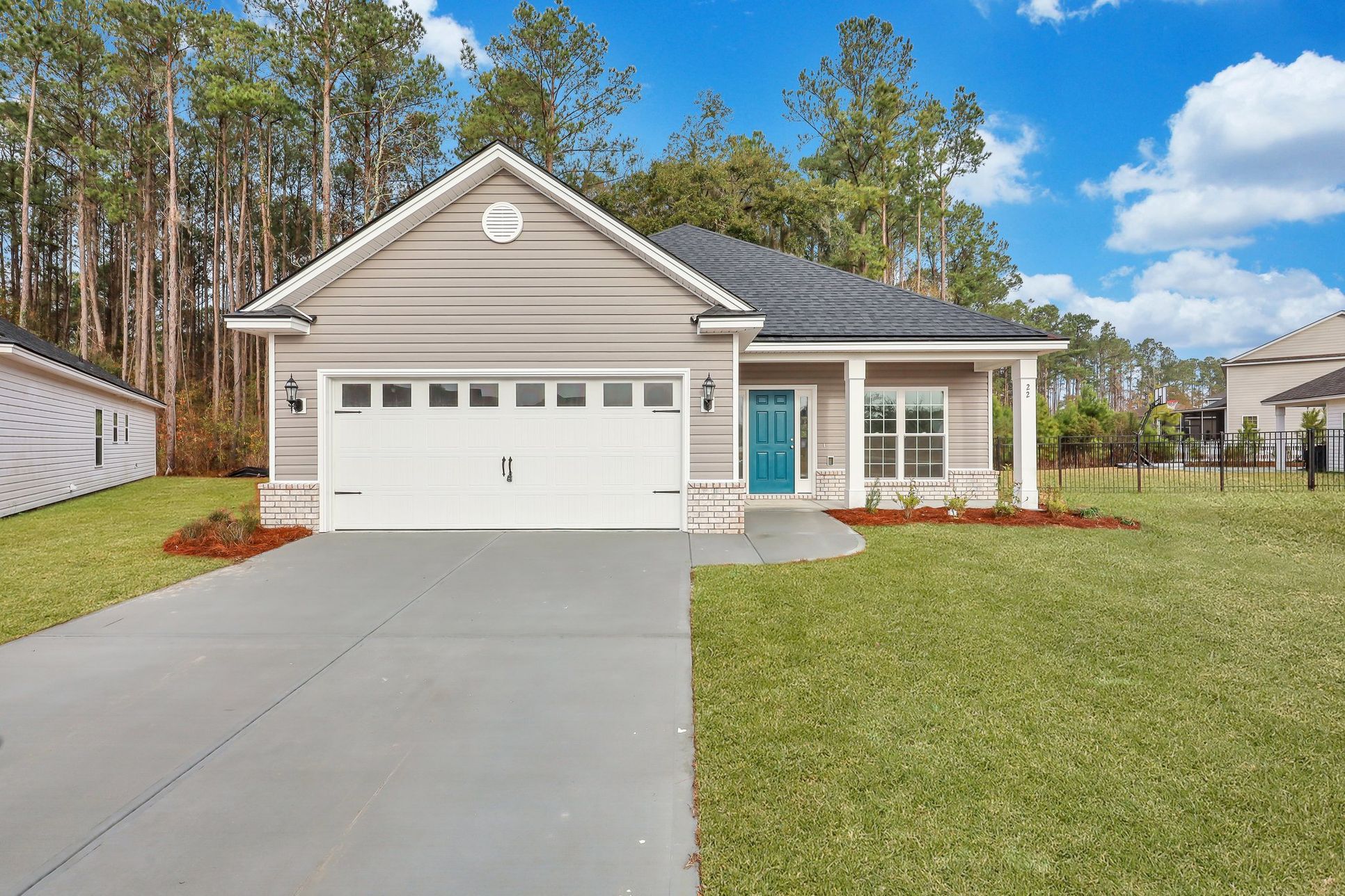 Front exterior of the Hampton floor plan with two-car garage and covered entry:Hampton – Front Elevation B