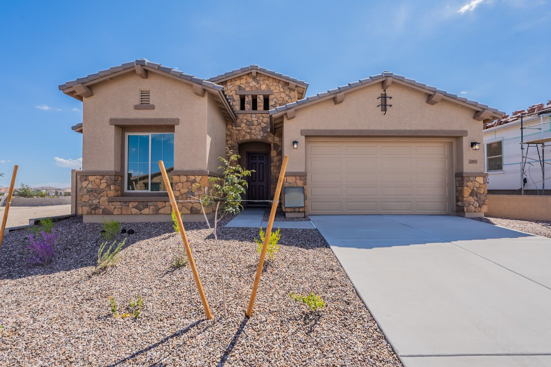 Stone-Accented Single-Family Home Design with terracotta tile roof.:Experience luxury in Canyon Views with its terracotta tile roof and Stone-Accented Home that evoke timeless elegance.