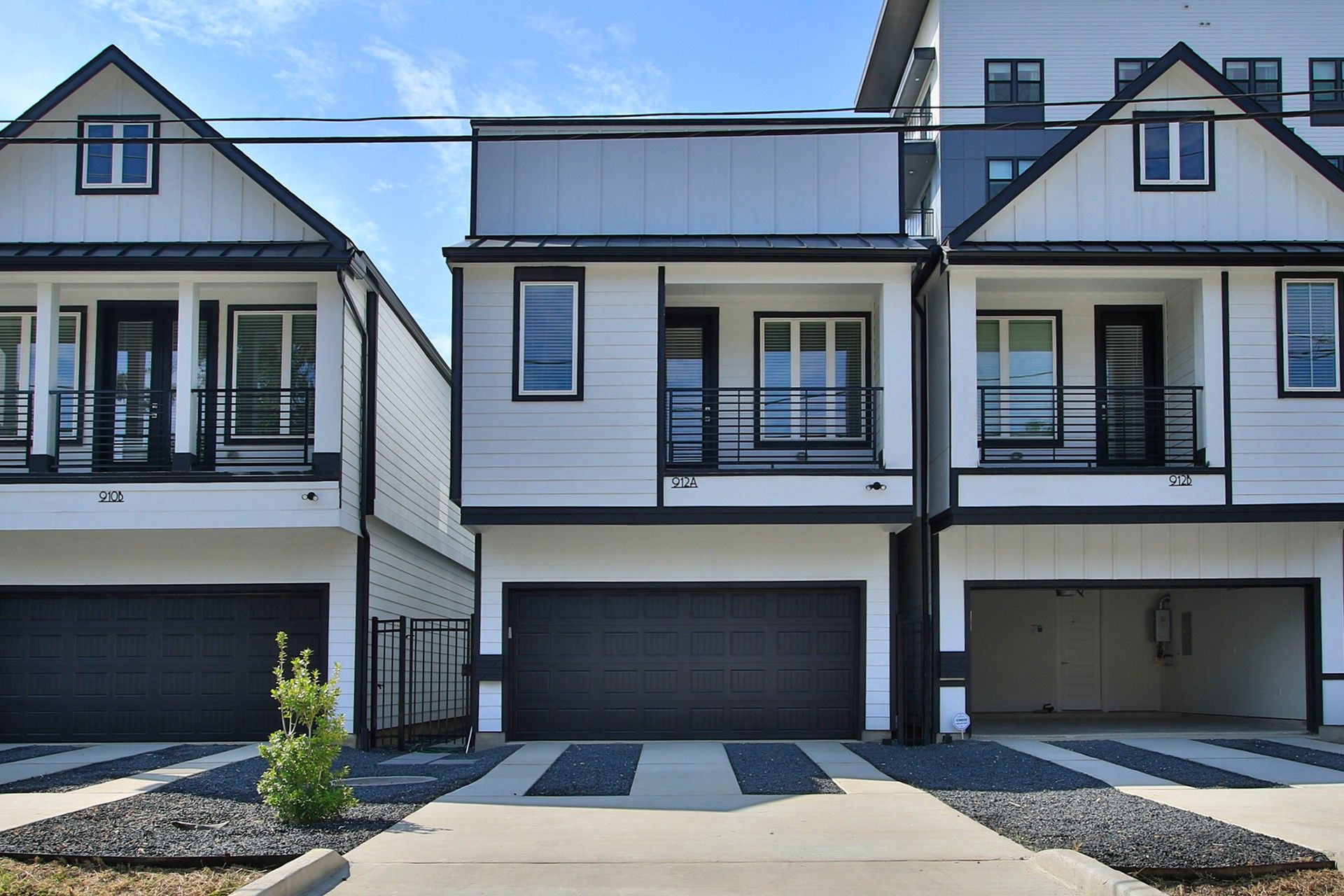 Two-story Home with Balcony and Garage in Shady Acres:Elegant Shady Acres home features a gray facade, expansive balcony, and sleek modern architecture.