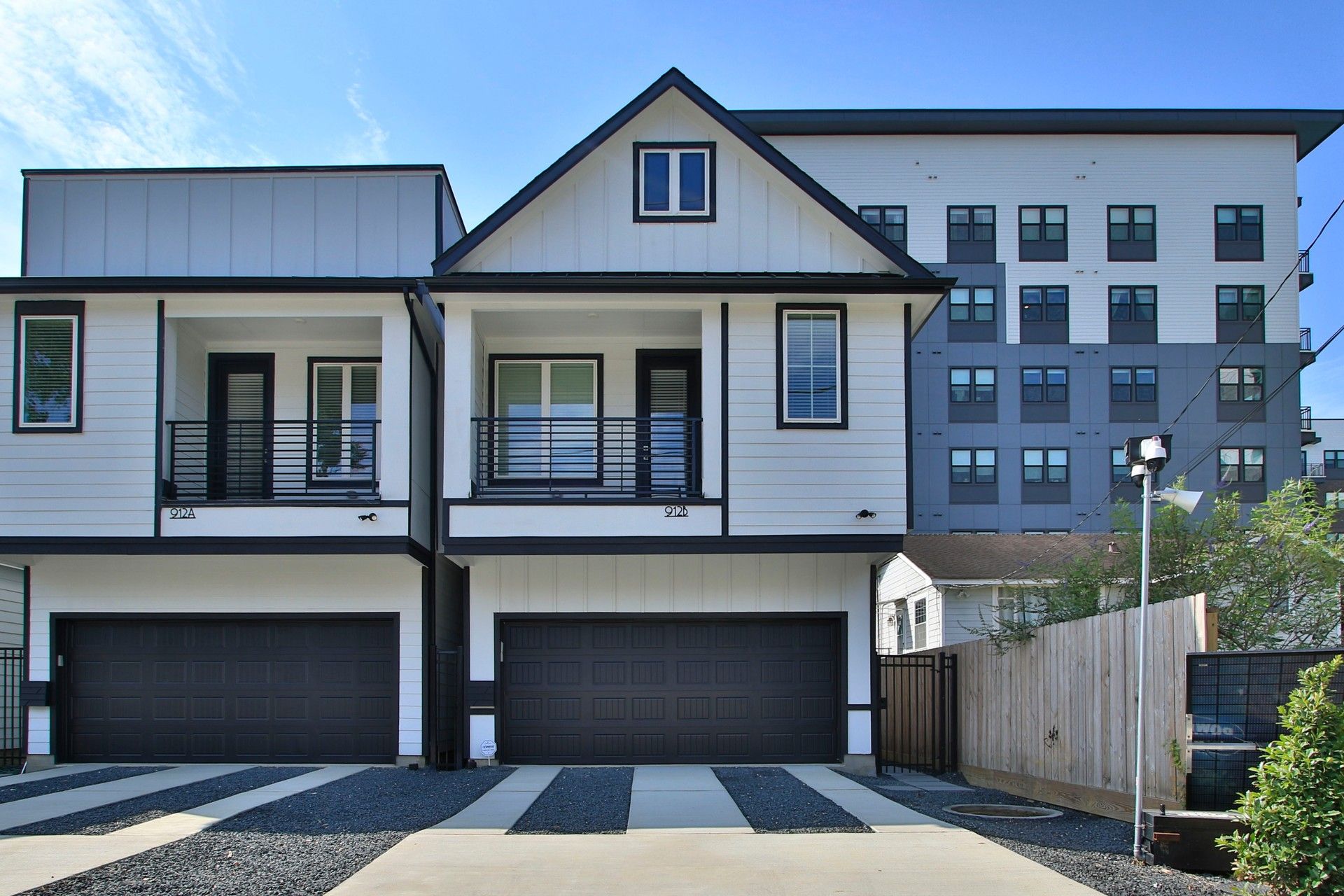 Shady Acres Detached Townhome Exterior at 912B W 21st Street, Houston:Sleek detached townhome facade with dual garages and modern design in Shady Acres, Houston.