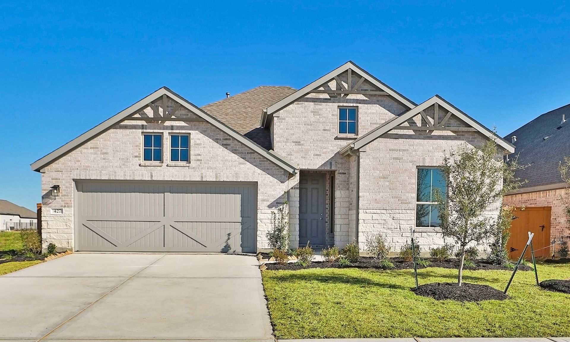 Modern Brick Home with Gabled Roof in River Ranch:Experience elegance in this River Ranch home with refined brickwork, gabled roof, and pristine landscaping.