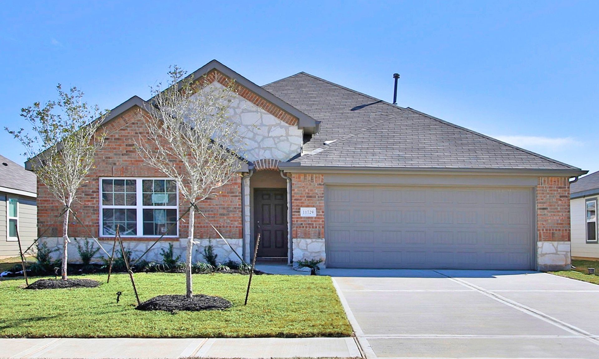 Modern Single-Story Brick Home in Cielo Neighborhood:Elegant brick facade with stone accents and dual garage in Cielo. Luxurious living in a modern design.