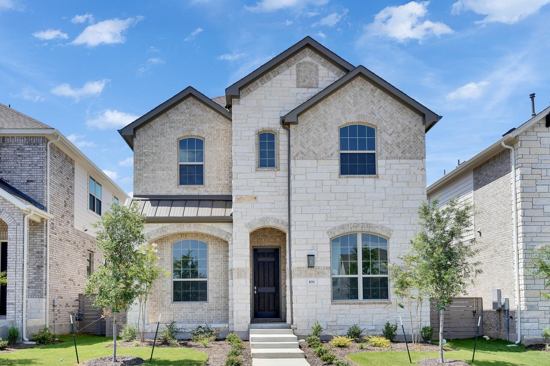 Stone Facade Two-Story House in Suburban Neighborhood:Exquisite stonework and elegant archways define this stunning residence, set in a serene suburban locale.