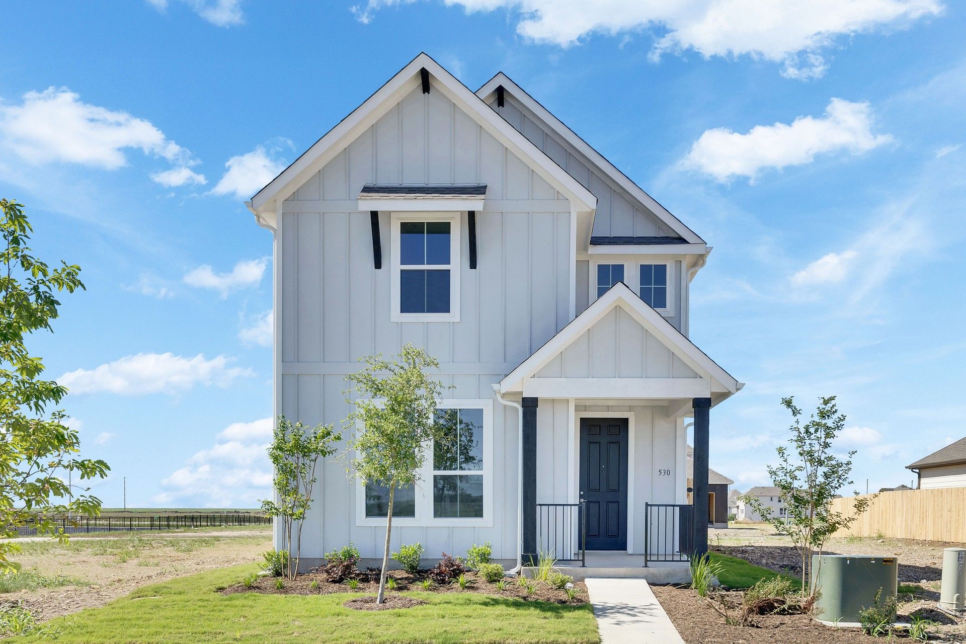 Modern White Gable House in Spring Creek Suburban Neighborhood.:Experience elegant design with gable roofing, expansive windows, and charming porch in Spring Creek.