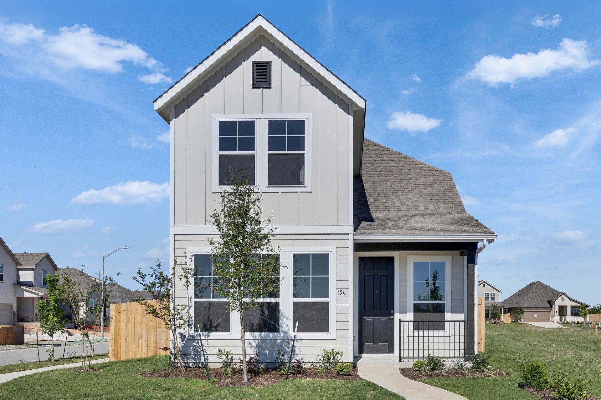 Modern Two-Story Home with Gable Roof in Spring Creek:Elegant gable roof, pristine white siding, and sophisticated black door define this Spring Creek masterpiece.