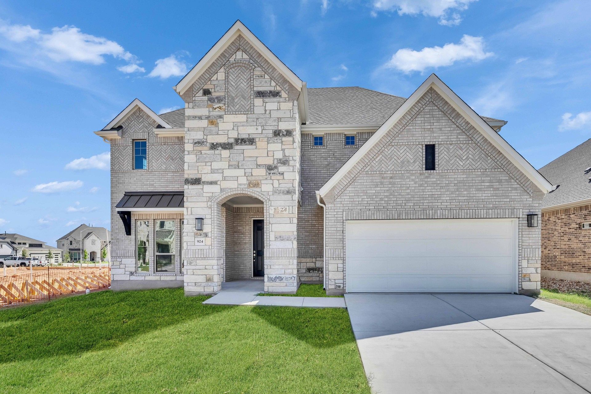 Majestic Stone and Brick House in Hawkes Landing:Exquisite stone facade, arched entry, and lush landscaping in Hawkes Landing create unparalleled elegance.