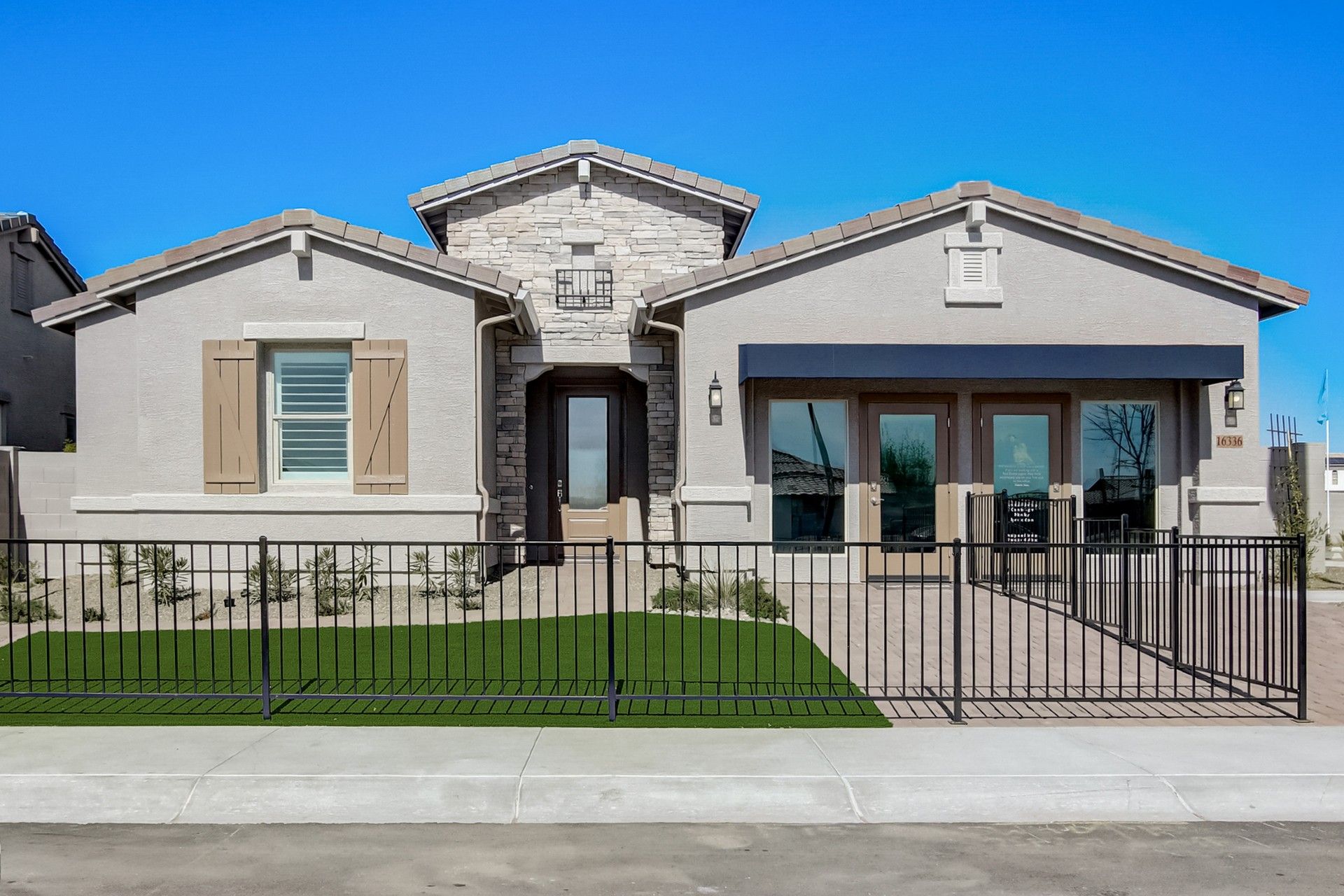 Modern Beige House at Mirada Crossing, Arizona:Elegant stone facade, dual entrance design, and pristine landscaping define this stunning Mirada Crossing residence.