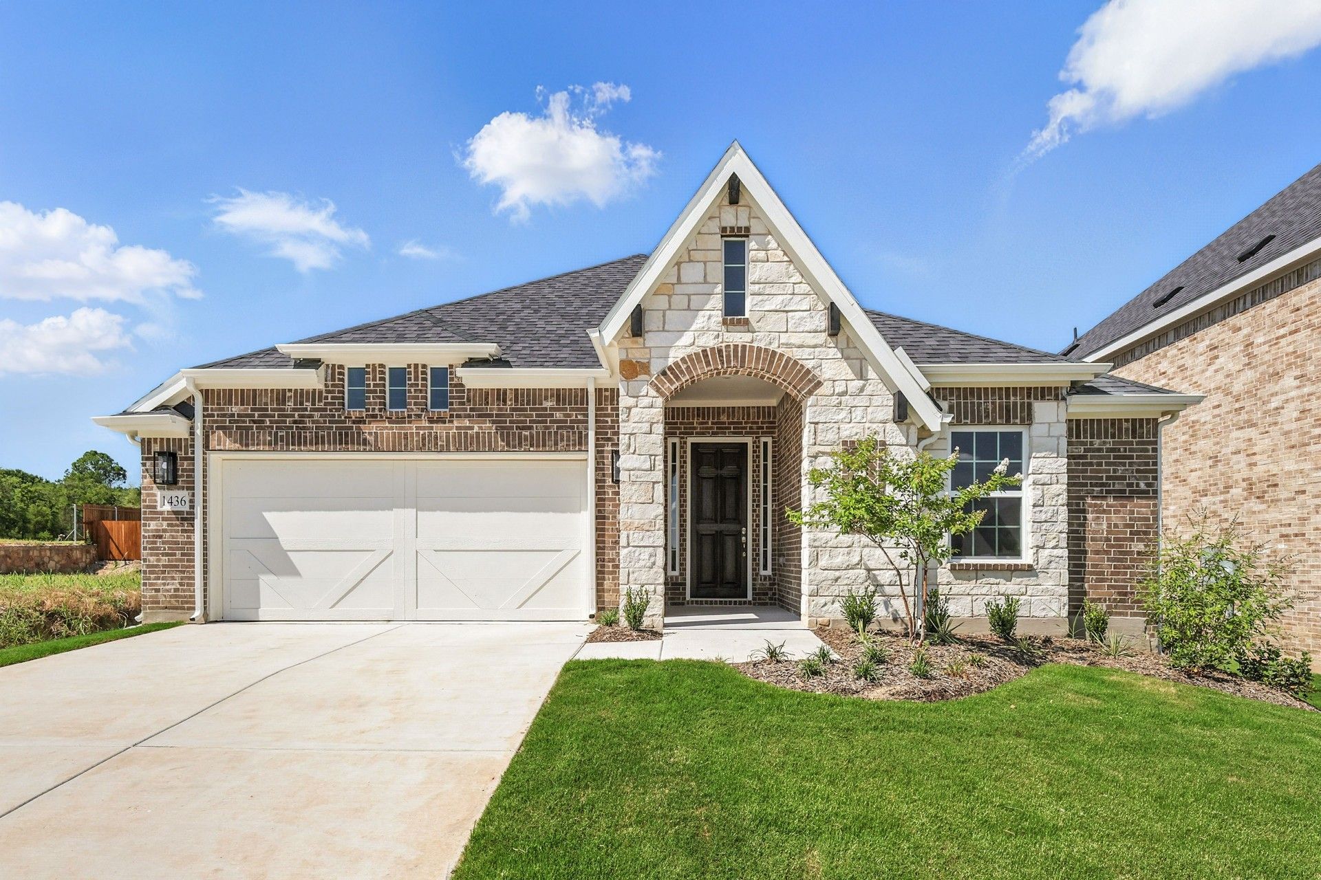 Elegant Stone and Brick Home in Green Oaks Preserve:Distinguished stone facade and immaculate landscaping enhance this Green Oaks Preserve residence's sophistication.