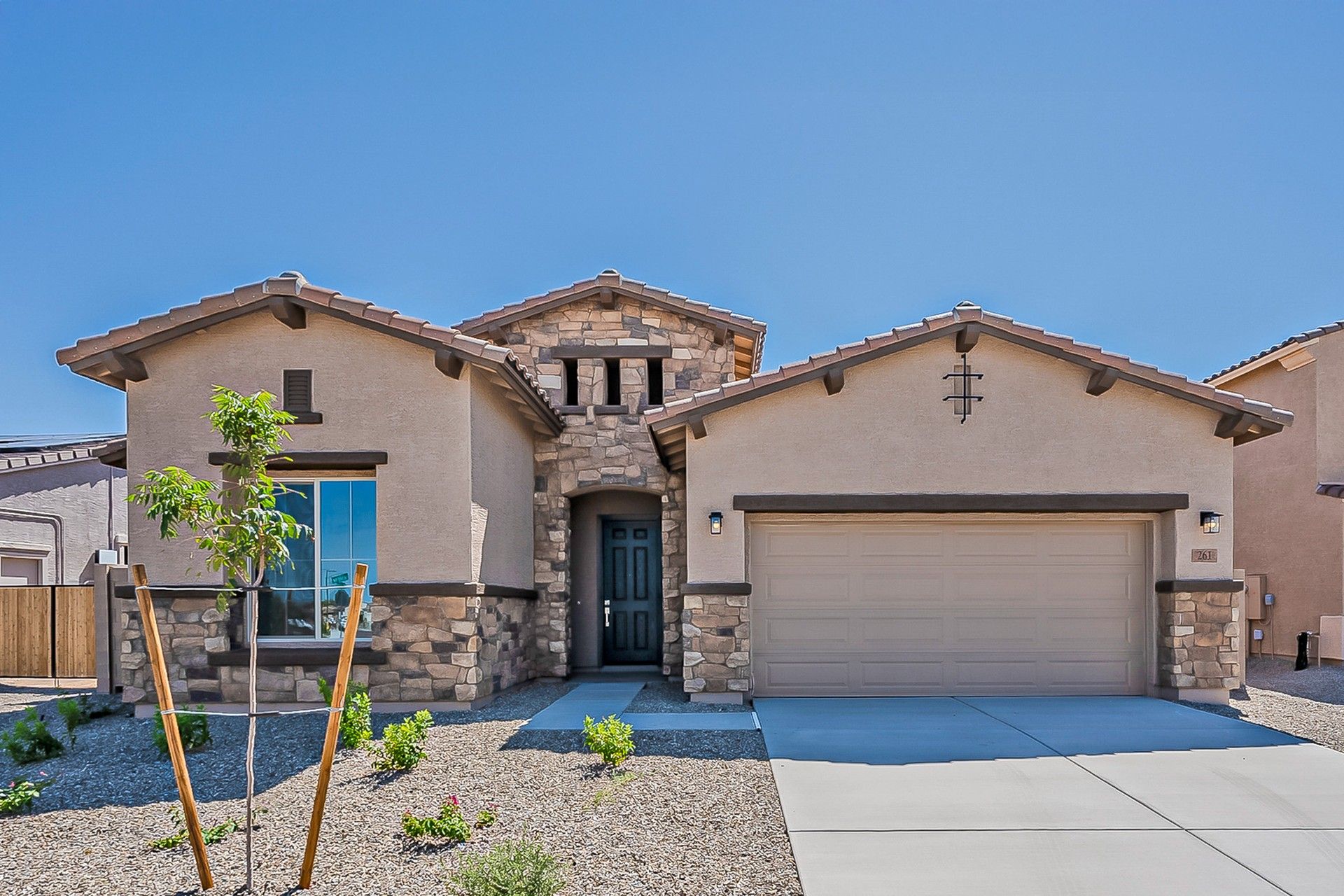 Modern Stone-Accent Home in Mirada Crossing with Desert Landscaping:Experience elegance with stone accents, stucco walls, and a tile roof in Mirada Crossing's luxurious setting.