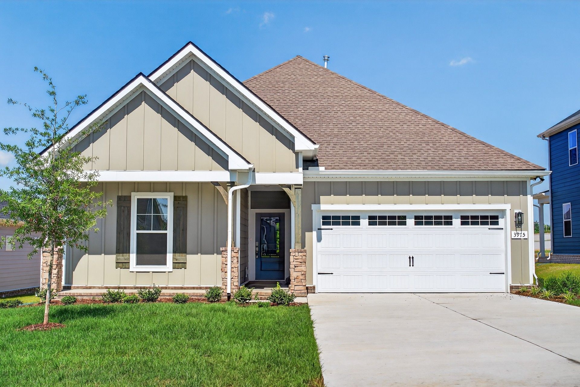 Modern Farmhouse with Gable Roof in McClure Farms:Stylish gable roof and stone accents enhance this McClure Farms home's refined suburban elegance.