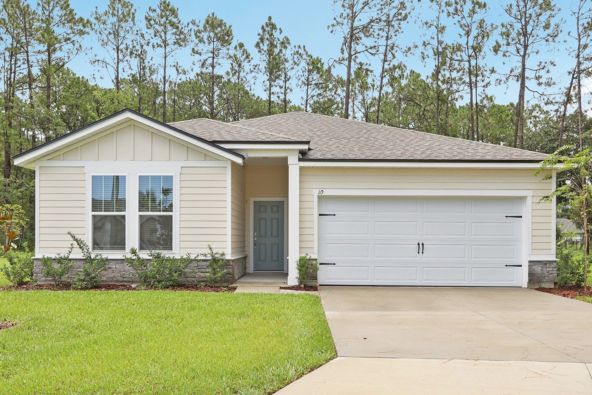 Ranch-Style Home with Garage in Palm Coast:Sleek ranch-style elegance with a spacious garage and light siding in tranquil Palm Coast setting.