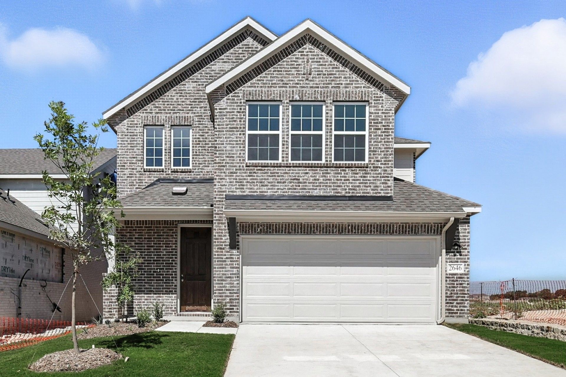 Modern Brick House in Meridian at Churchill Residential Area:Experience elegant brick design and spacious living at Meridian at Churchill, featuring expansive windows and a manicured lawn.