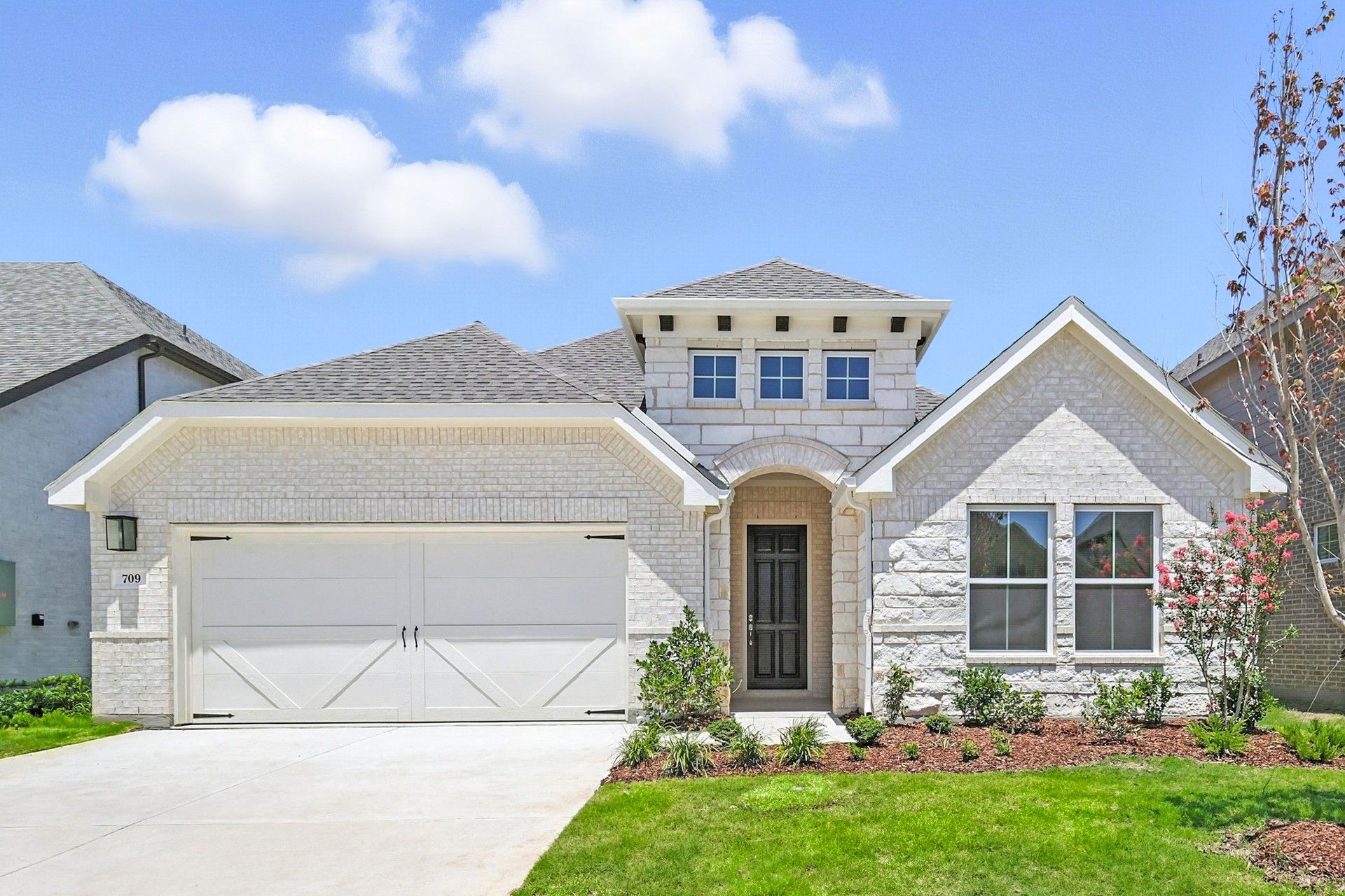 Modern White Brick Home at Wildflower Ranch with Gabled Roof:Revel in the elegance of this white brick facade and gabled roof at Wildflower Ranch, exuding refined architectural charm.