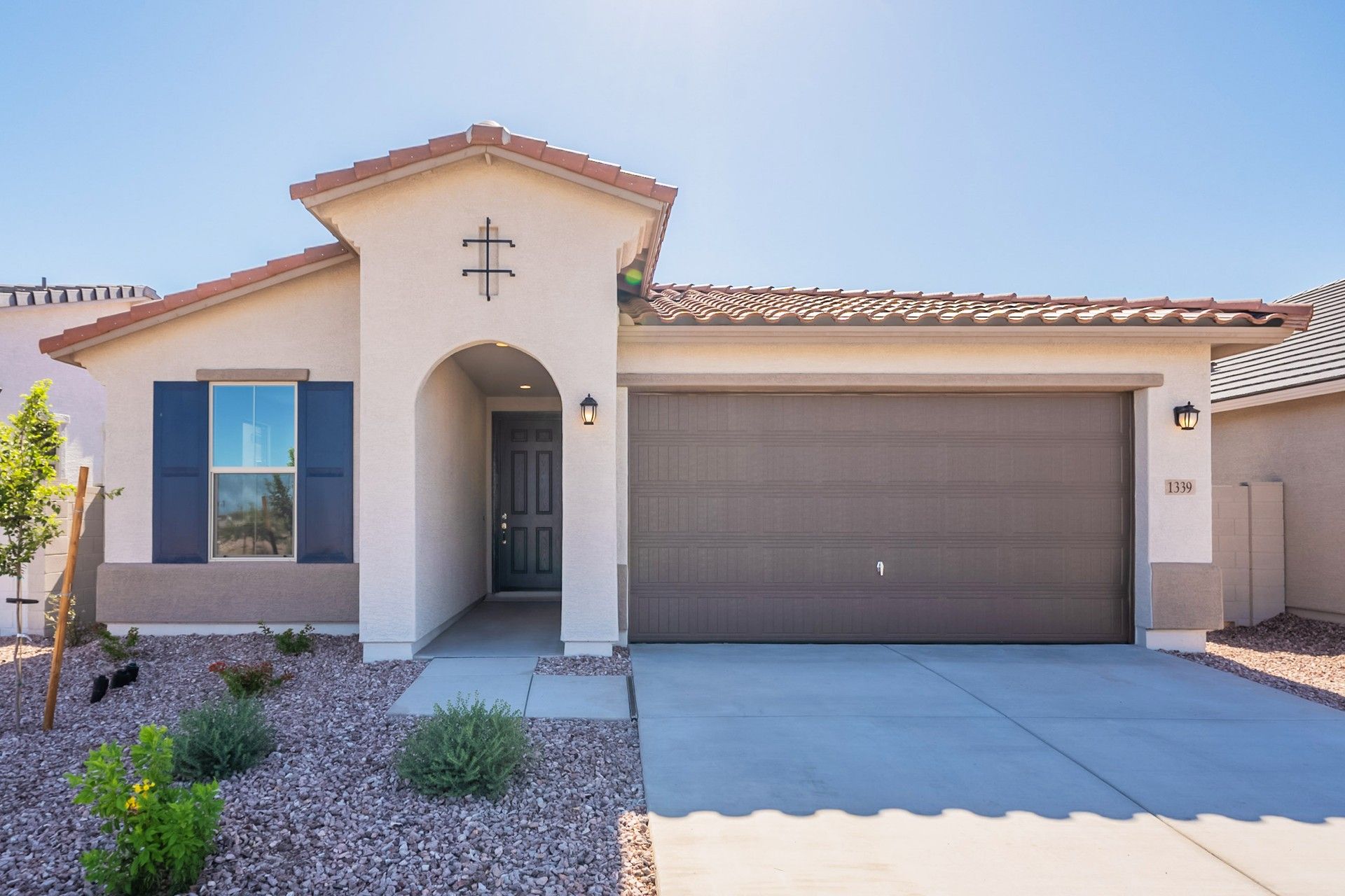 Modern Stucco House with Terracotta Roof at Sienna Park:Elegant arches and terracotta tiles define this Sienna Park gem, beautifully set amid exquisite desert landscaping.