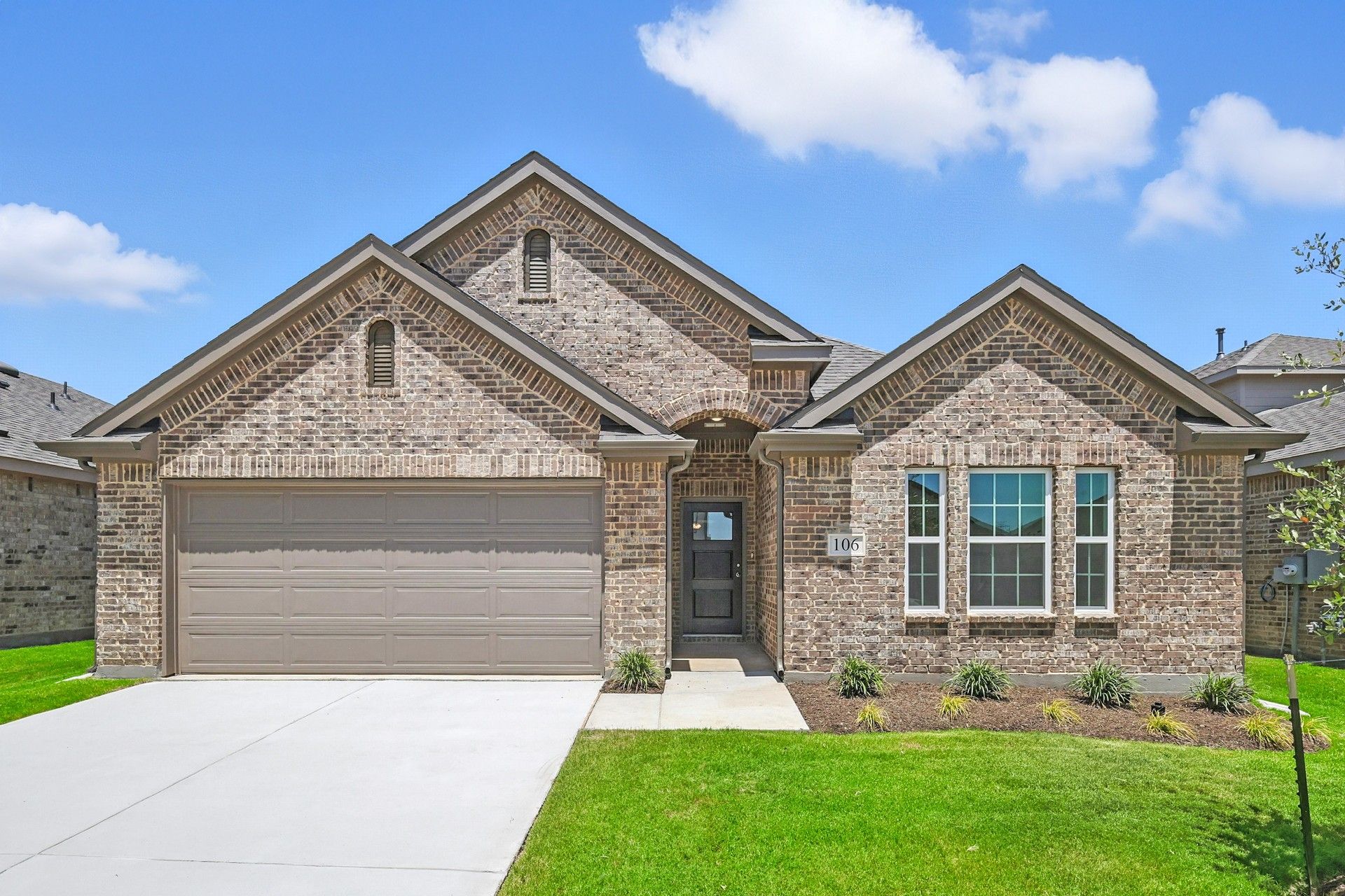Brick Home with Gabled Roof and Garage in Blanton Patriot Estates:Exquisite brick facade with elegant gables accentuates this Patriot Estates home's refined architecture.