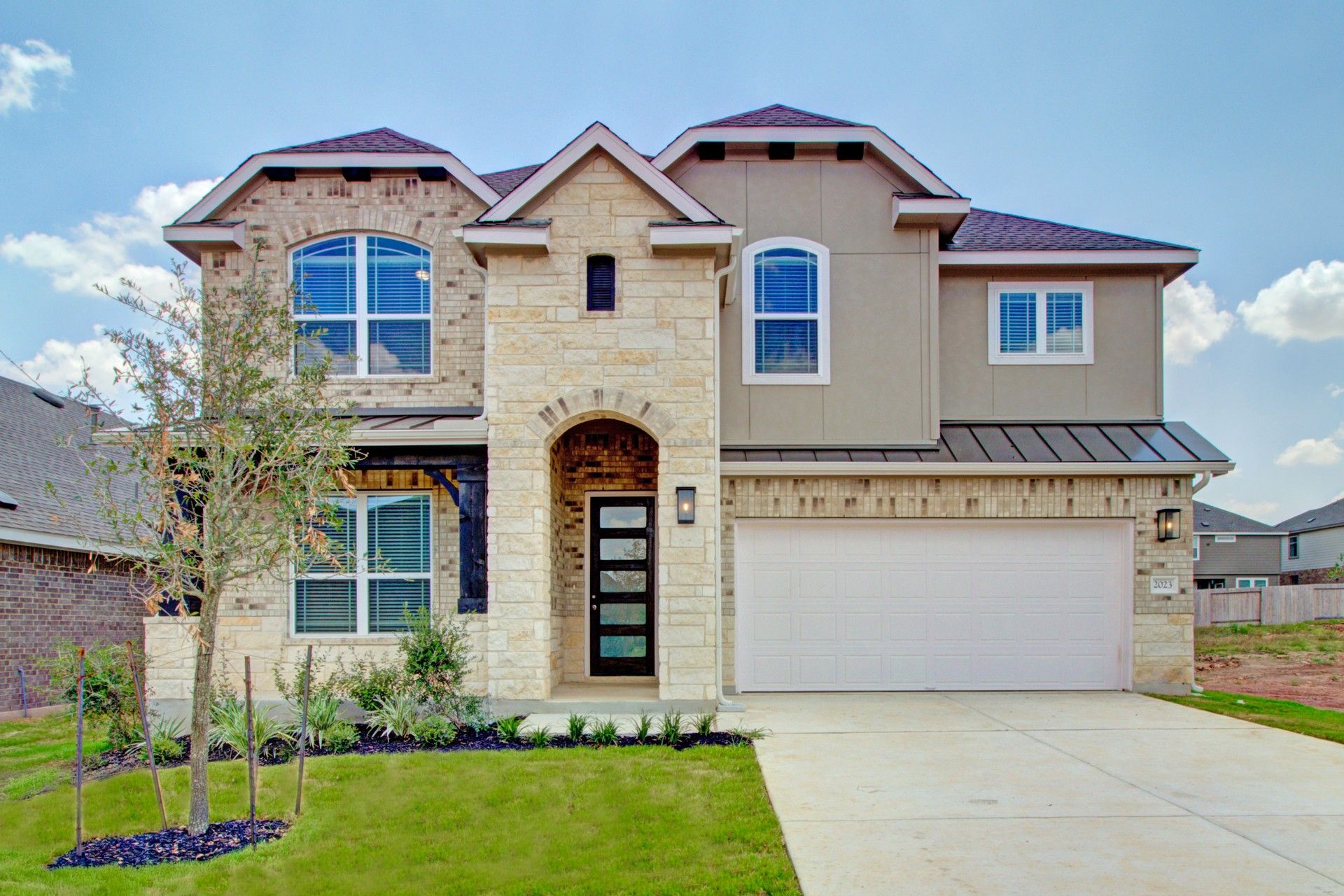 Two-Story Brick and Stone Home in Veramendi Neighborhood:Elegant gabled roof and mixed brick-stone facade define this sophisticated Veramendi residence.