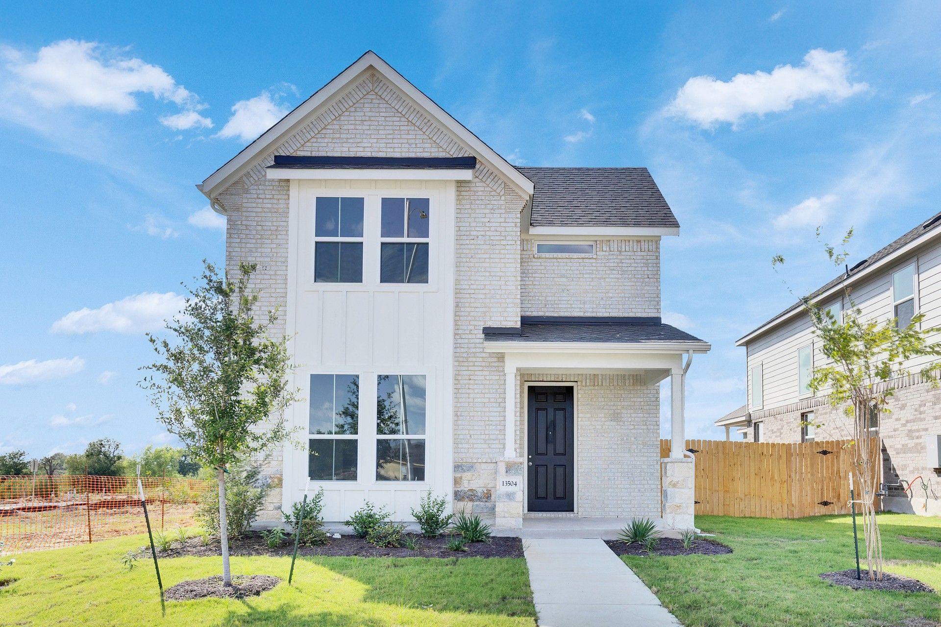 Elevation H:Distinctive brick facade and ample windows showcase modern elegance at this Creeks Crossing residence.