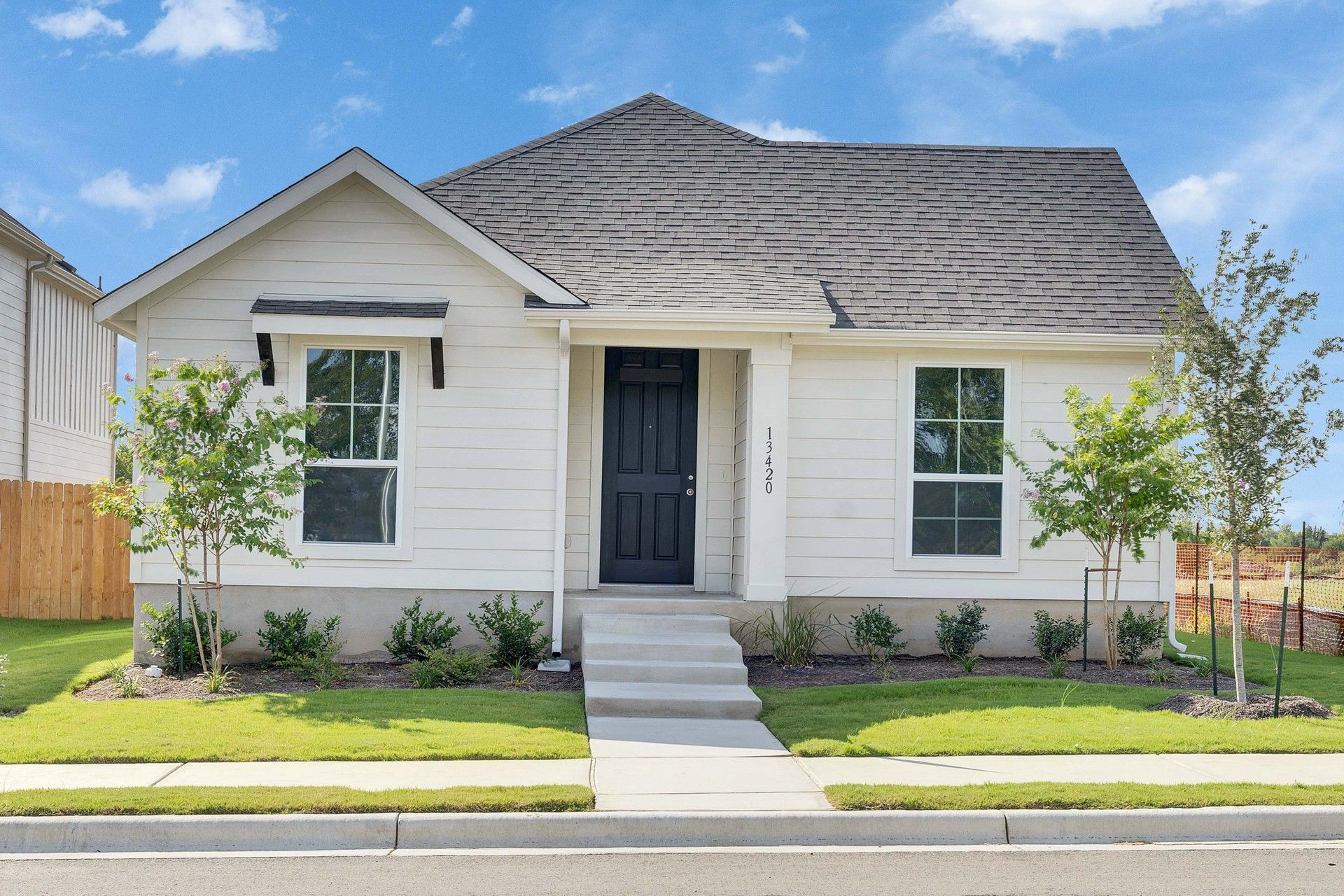 Elevation A:Elegant gabled roof and sleek beige siding define this Creeks Crossing residence's sophisticated charm.