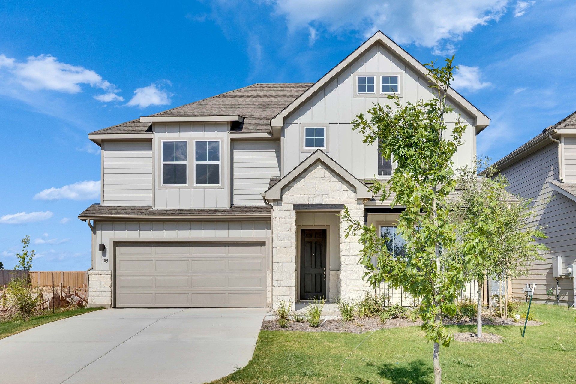 Spring Creek Magnolia Plan Home at 105 Greinert Drive with Stone Facade:Elegant stone facade and lush landscaping at 105 Greinert Drive in Spring Creek.