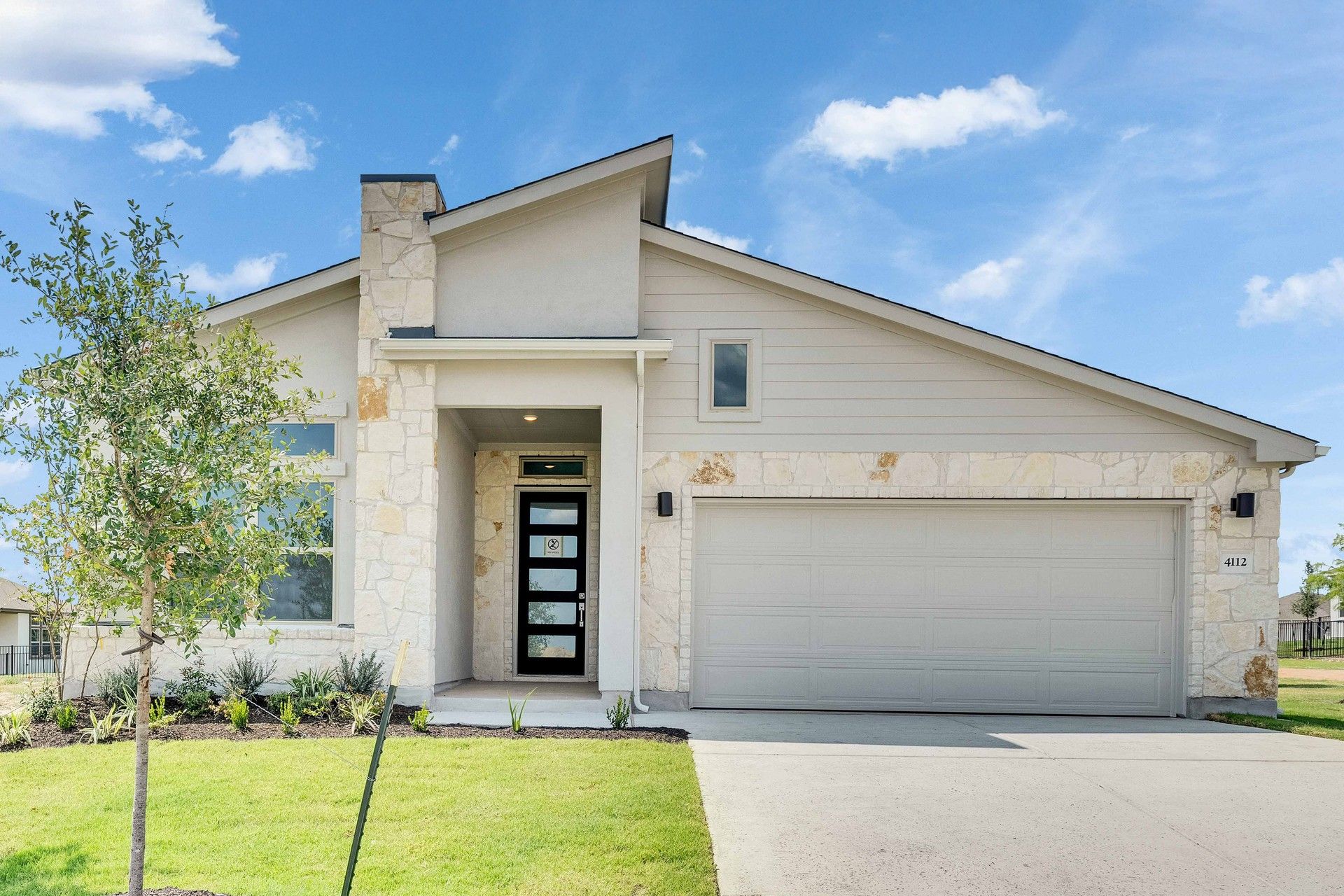 Contemporary Stone and Stucco Home in Lakeside Meadows:Elegant gable roof and stone facade complement the landscaped entrance in stunning Lakeside Meadows.