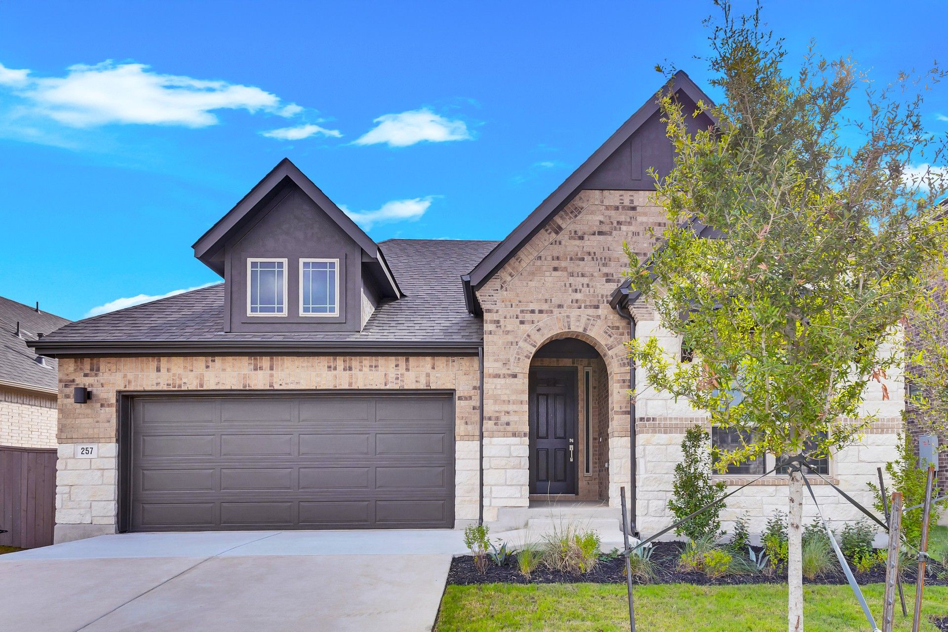 Anthem Premier Oleander Home at 257 Du Bois Ln with Tandem Garage:Elegant brick facade with tandem garage and archway in Anthem's Premier Oleander plan.