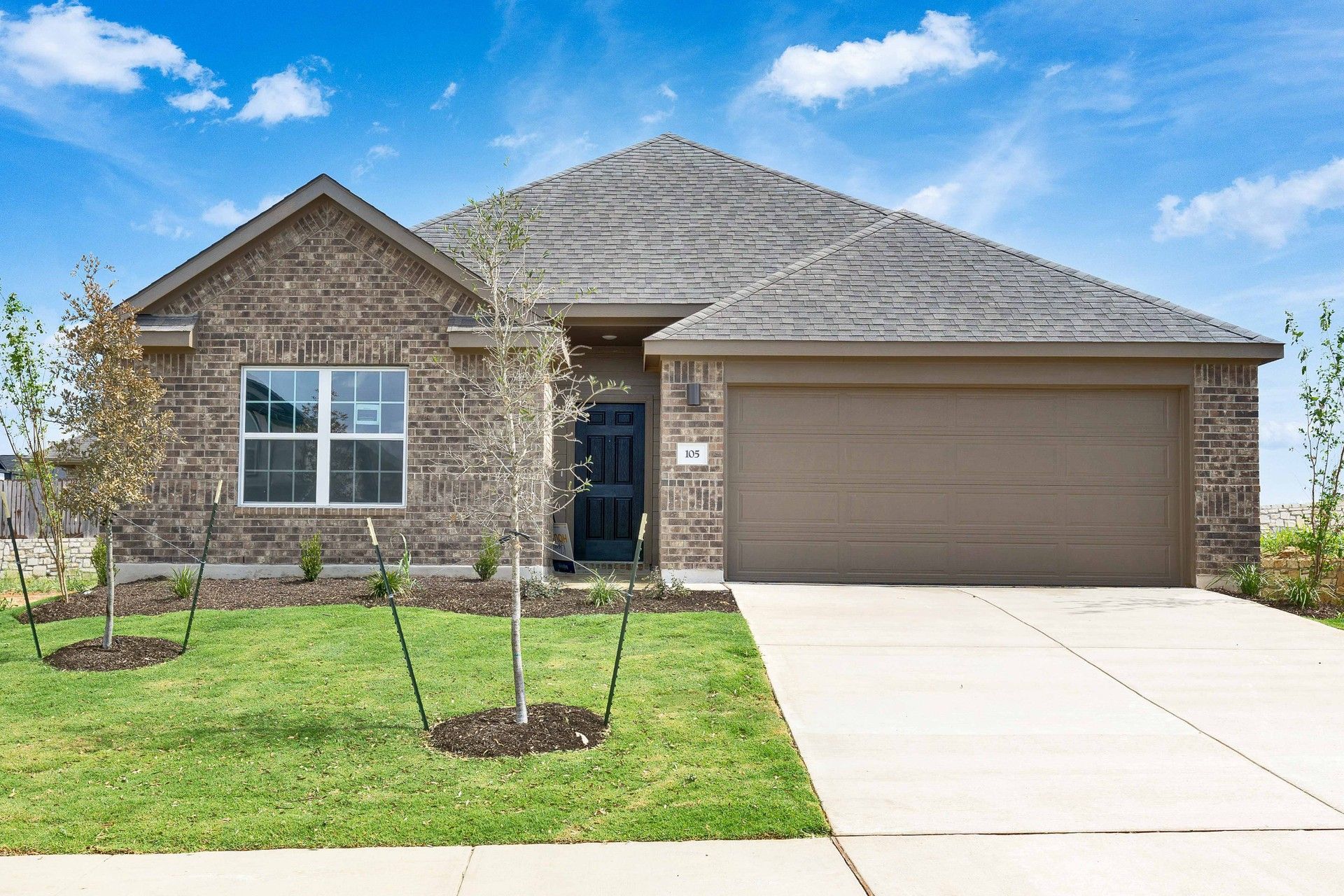 Elevation M:Sophisticated red brick facade and pristine landscape in Blanton at Hunters Glen offer classic suburban elegance.