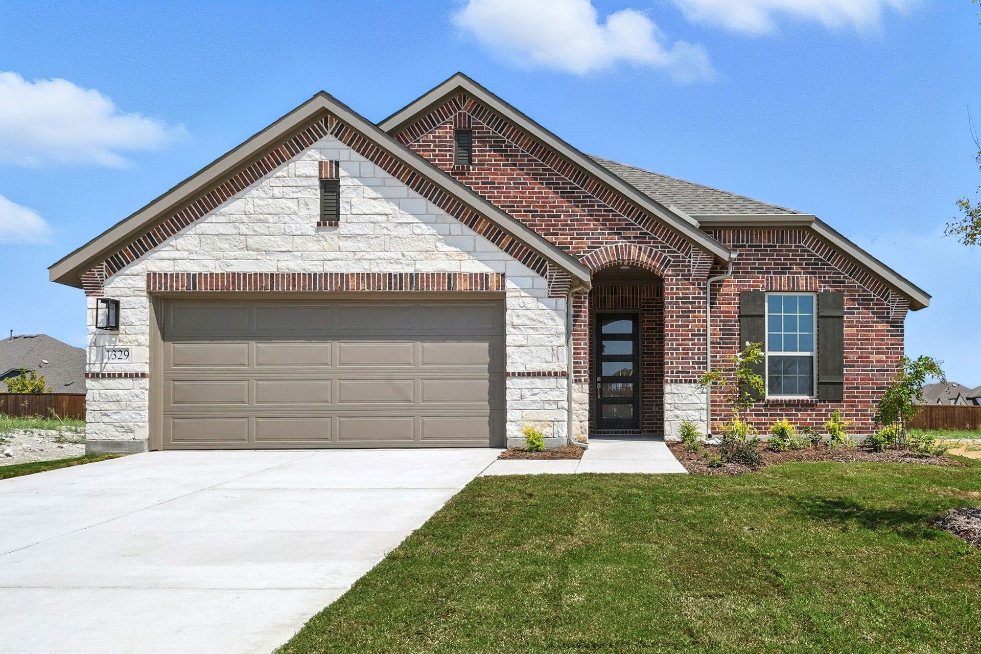 Elegant Stone Home with Gabled Roof at Palm at Anna Ranch, Texas:Exquisite stone facade and gabled roof define this elegant residence at Palm at Anna Ranch, Texas.