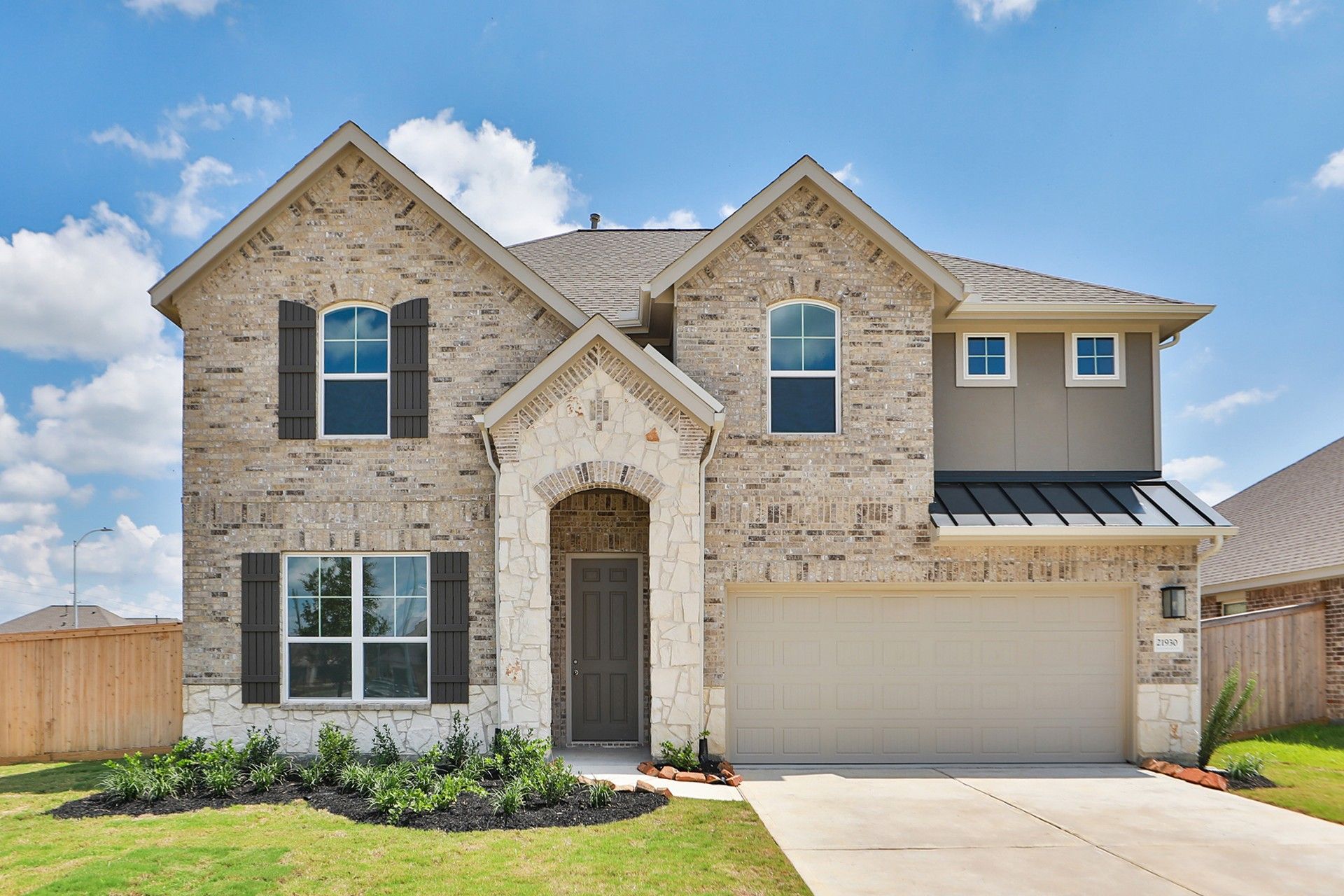 Two-Story Brick House with Arched Entry in Oakwood Estates:Stunning brick facade with arched stone entry, rich wood shutters in prestigious Oakwood Estates.