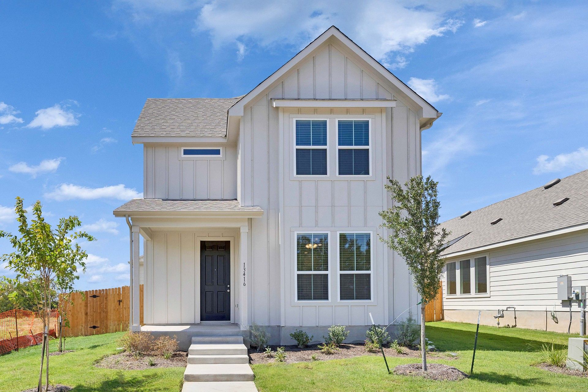 Creeks Crossing Elgin Home with Board-and-Batten Siding:Elegant board-and-batten facade enhances this Creeks Crossing home in Elgin.