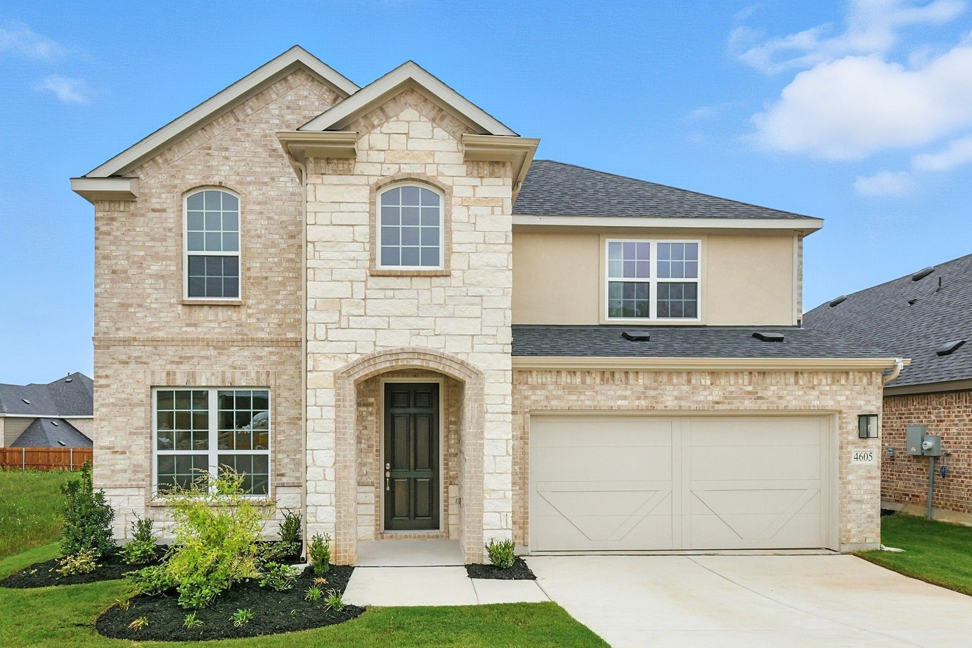 Two-Story Brick Home at 4605 Plumpjack Drive, Green Oaks Preserve:Luxurious brick facade with stone detailing in Green Oaks Preserve at 4605 Plumpjack Drive.