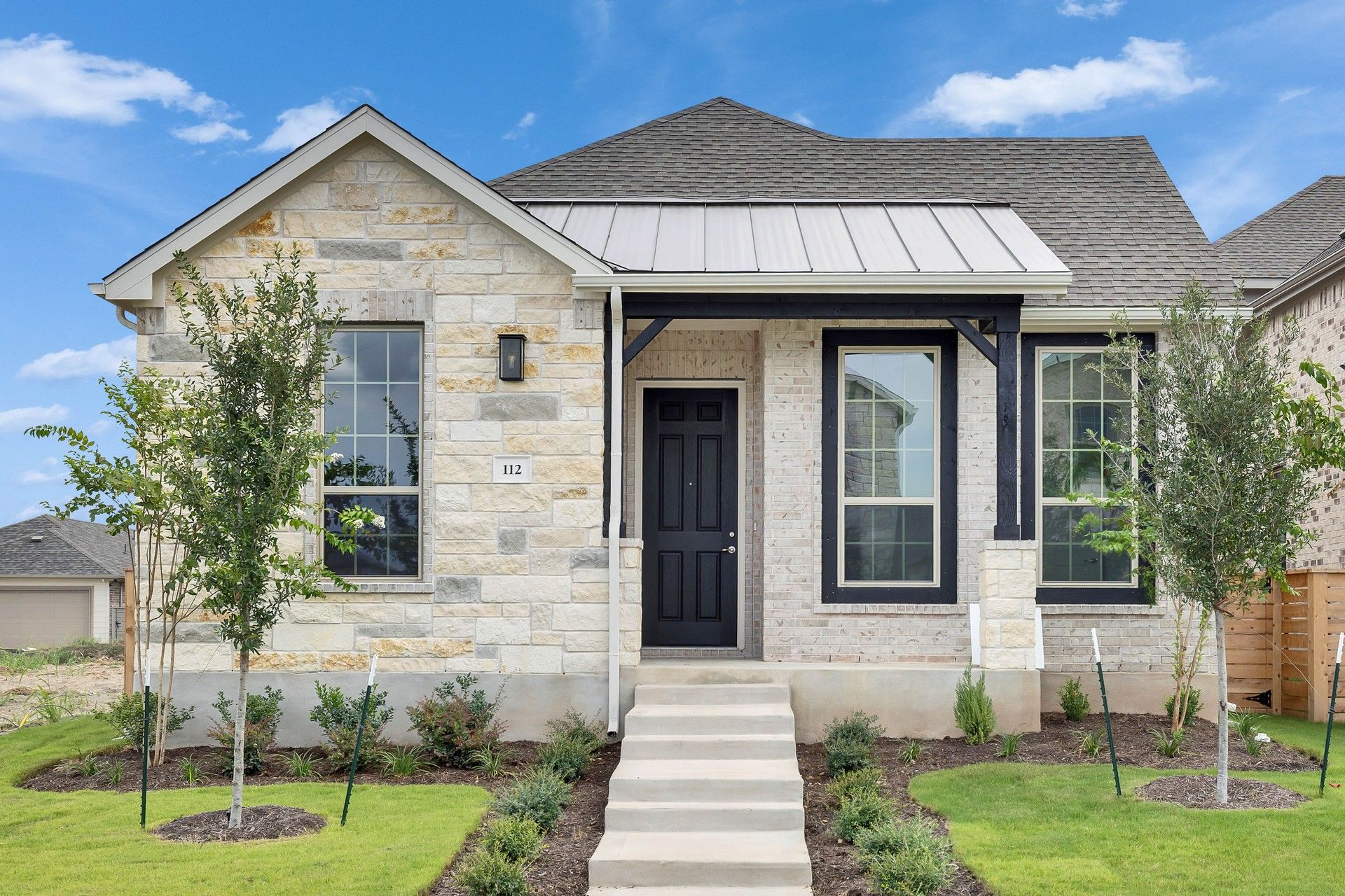 Stone-Clad Texas Home with Gable Roof in Suburban Setting:Elegant stone facade and gable roof define this luxurious Texas abode, set amid meticulously landscaped grounds.