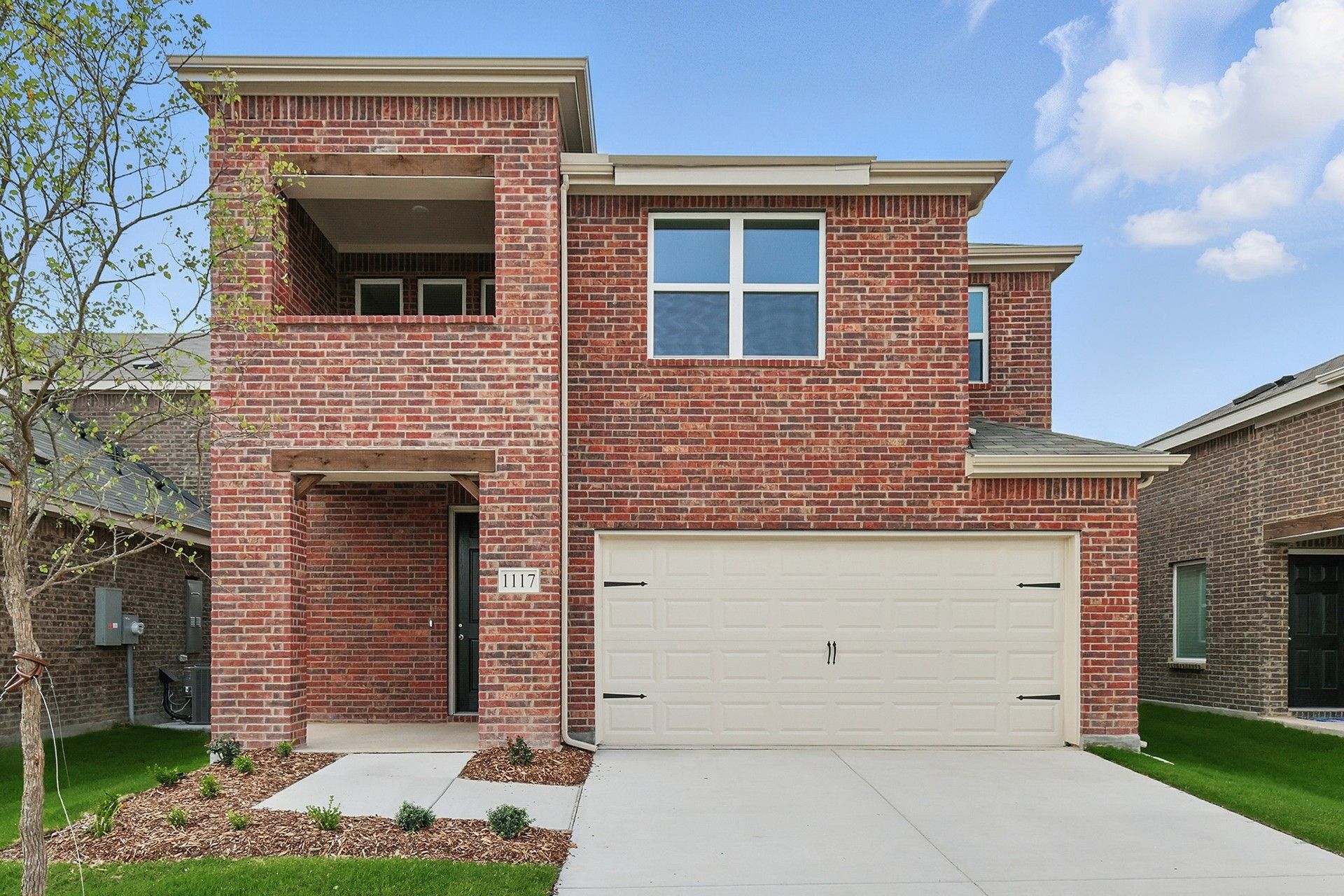 Two-story brick home in Walden Pond, Journey - Meridian plan, 1117 Baker Bridge:Elegant brick facade with modern design at 1117 Baker Bridge Drive in Walden Pond community.