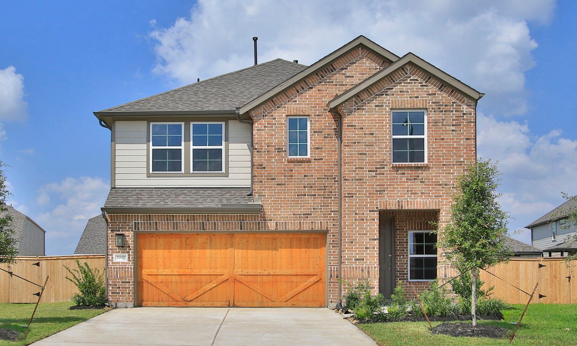 Two-Story Brick Home in Eldridge, Texas with Gable Roof and Large Windows:Timeless brick façade, expansive windows, and a gable roof elevate this Eldridge home to high architectural standards.