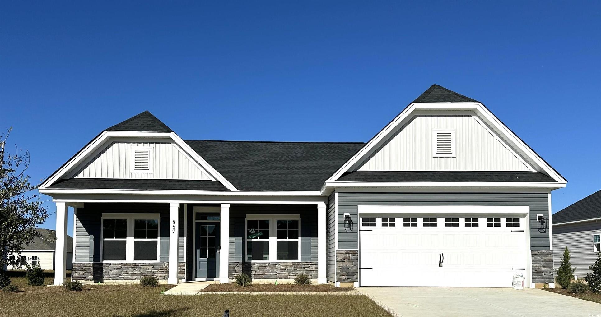 Exterior:View of front of property with stone siding, covered porch, board and batten siding, and roof with
