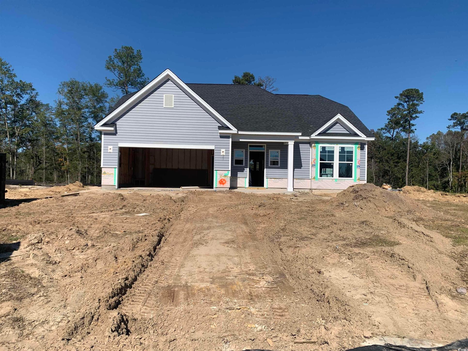 Exterior:View of front facade featuring covered porch, driveway, and a shingled roof