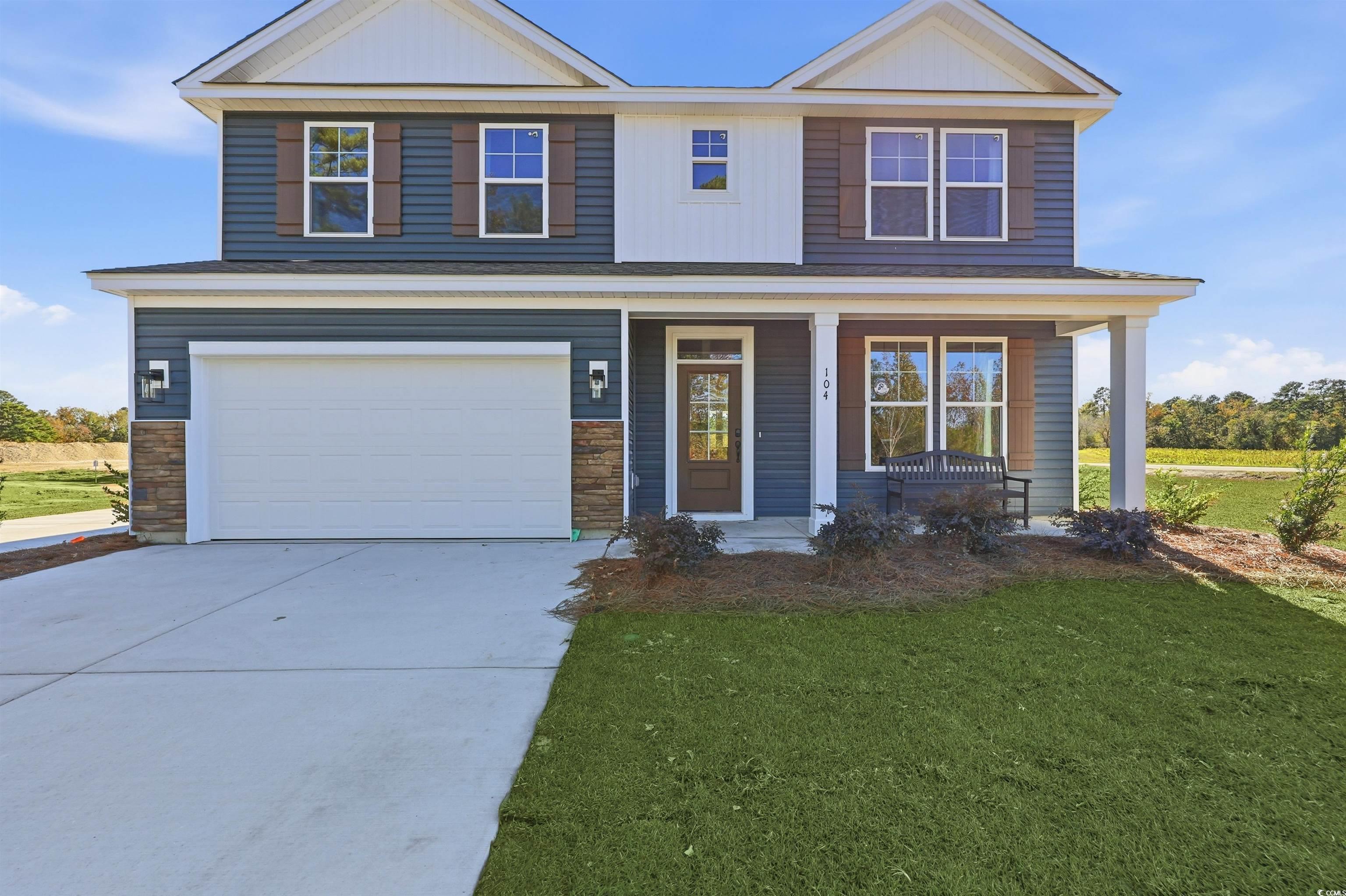 Exterior:View of front of house featuring a front lawn, a porch, concrete driveway, and stone siding